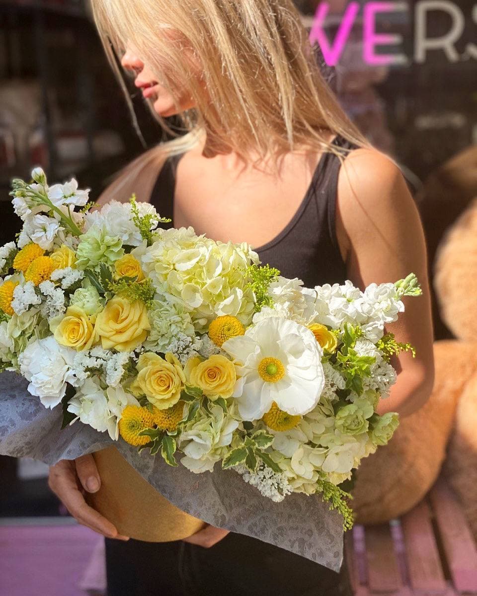 Sana - Sana is a stunning, bright composition of white hydrangea, garden roses, carnations and poppy flowers. 