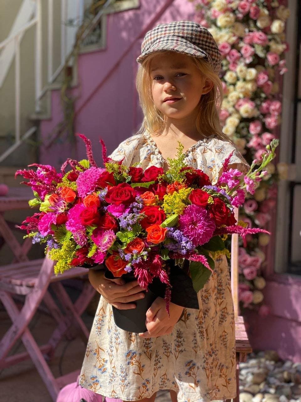 Oliveira - Oliveira is a stunning and bright bouquet that comes in variety of red and orange roses, vivid purple dahlias, stacks and chrysanthemums.