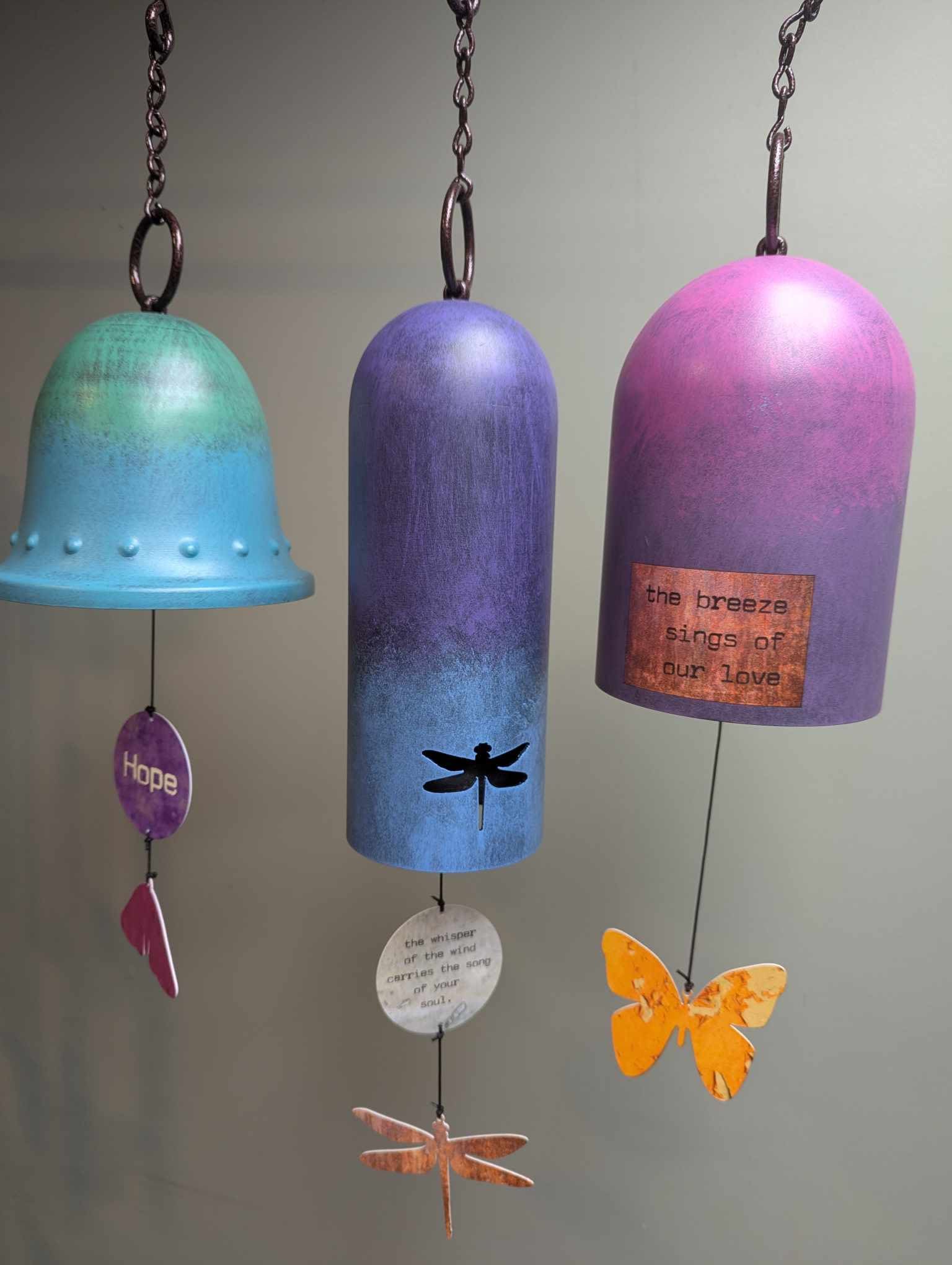 Inspirational Sentiments Wind Bell -  Bold and opulent. The thick hollow chambers and unique shapes and designs of this Wind Bell Collection produce beautiful reverberating sounds.  Weather resistant materials and finishes. 'Dragonfly', 'Butterfly' and 'Hope' styles. Standard pricing is in the box, Deluxe is displayed on an easel with a bow and the Premium choice is displayed on an easel with a bow and a spray of silk flowers