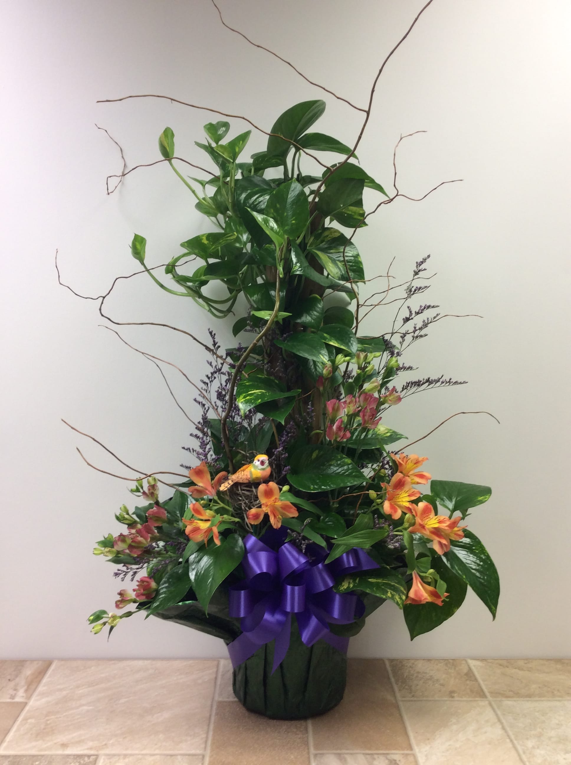 Pothos Pole, decorated Pothos Pole, decorated - Our Pothos plant is tall, dramatic, and easy to grow. We’ve decorated it with seasonal fresh flowers, curly willow, and a pretty foil and bow. (Approximate size: 38” tall and 24” wide)