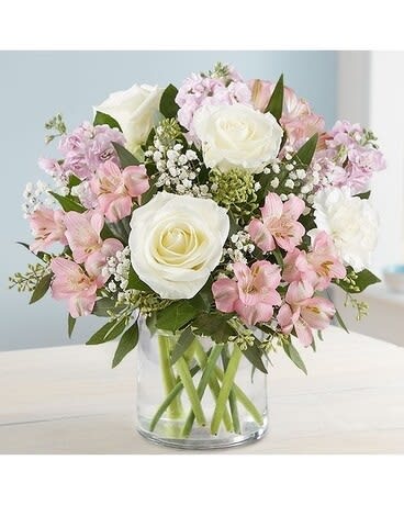 Elegant Blush - Our elegant bouquet in shades of blush pink and creamy white brings all the charm of a rustic country garden to the people you care about. Cascading blooms are hand-gathered with lush greenery inside a clear cylinder vase, creating a beautiful gift that delights with every detail. 
