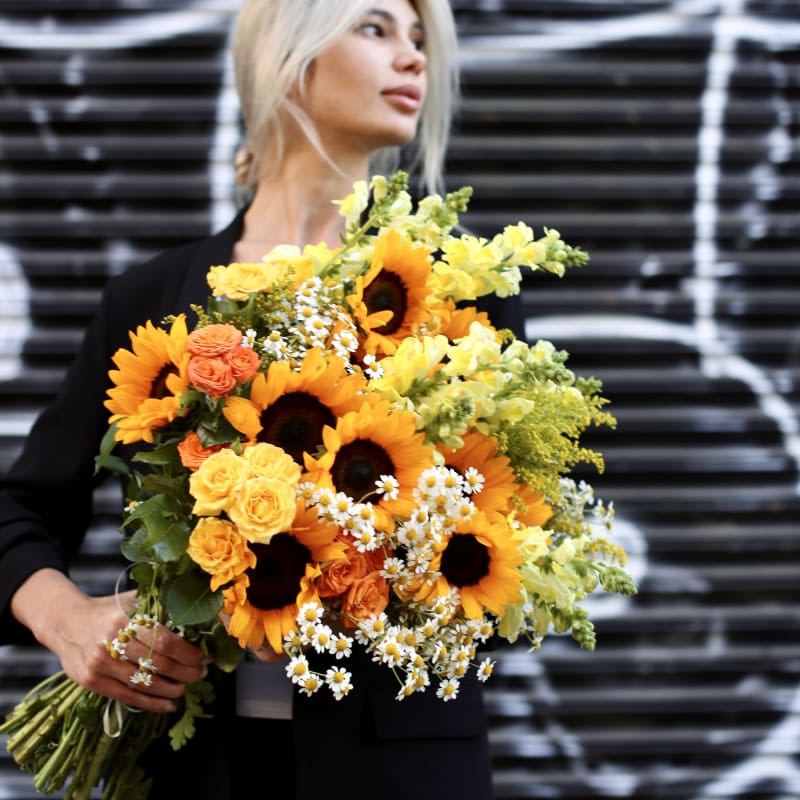 Spring bouquet - Sunflowers spring bouquet is a sunny and bright flower arrangement with sunflowers, daisies, roses, and greenery. 