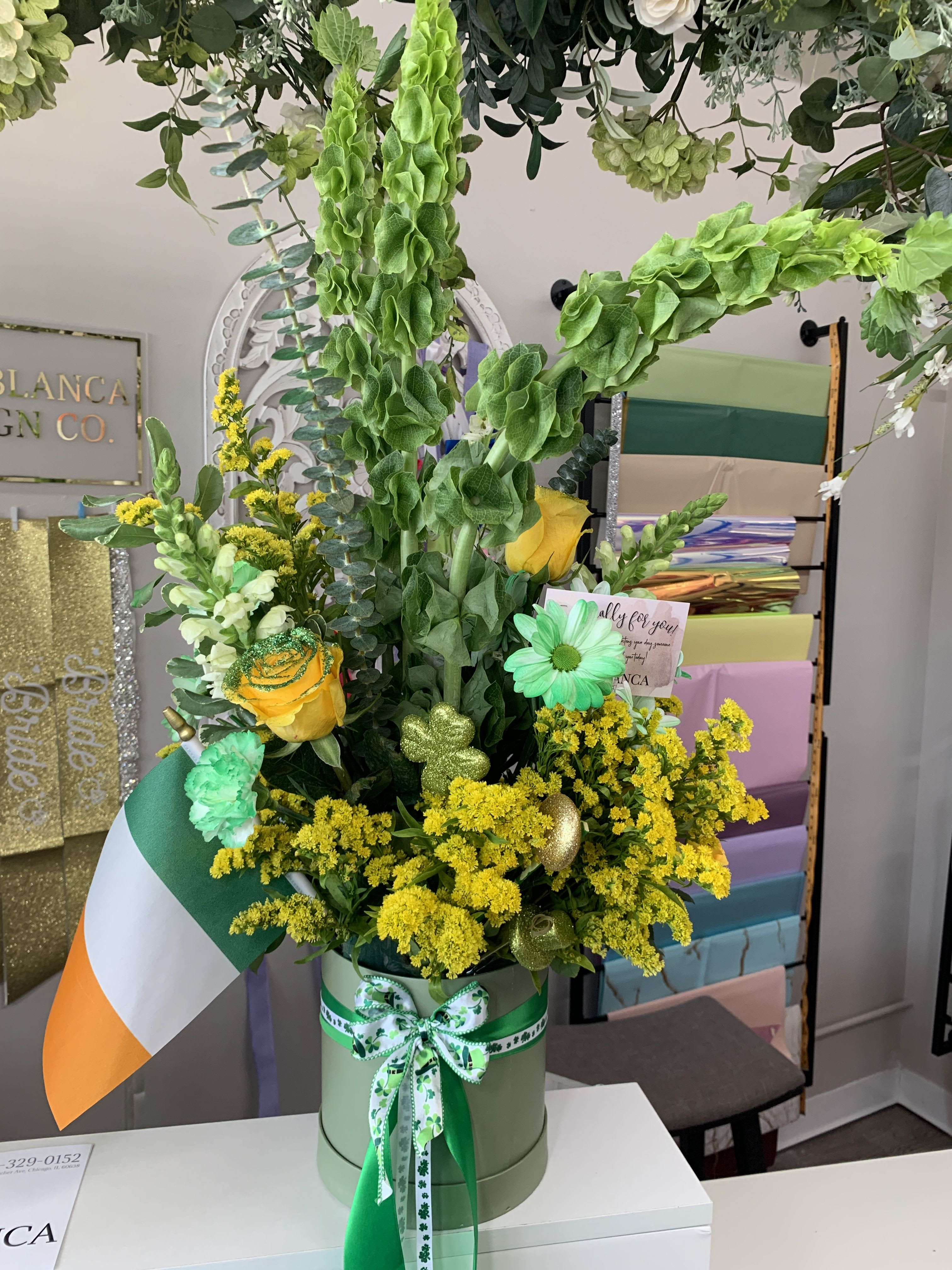 Goldenrod Goldenrod - Irish themed round box bouquet. Includes bells of Ireland.
