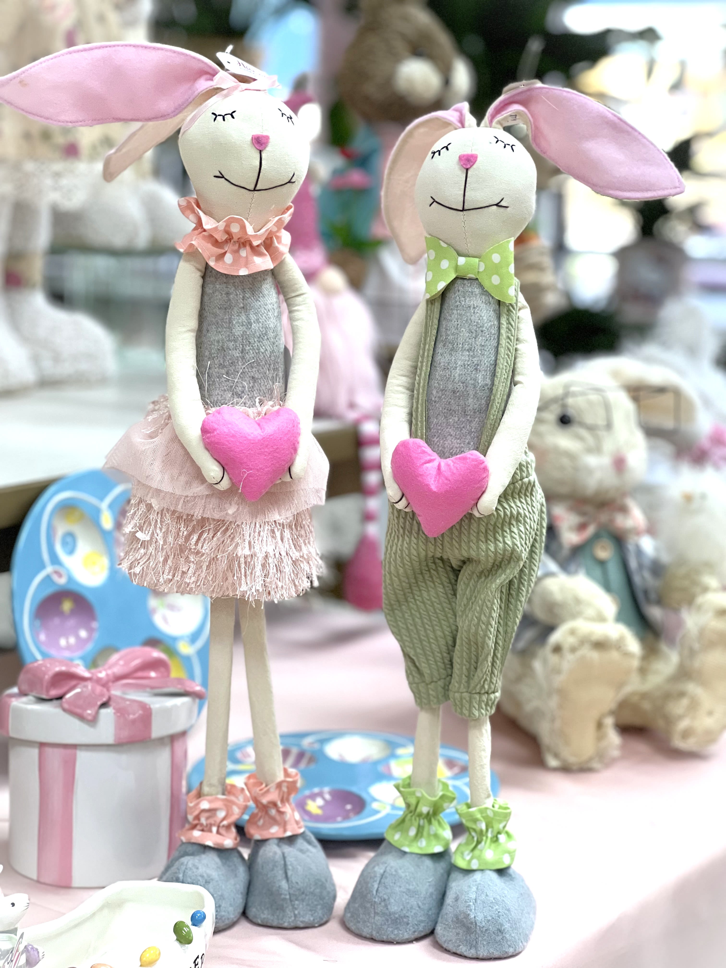 Easter Standing Bunny COUPLE With Heart | 48cm Easter Standing Bunny COUPLE With Heart | 48cm - 48cm: · Size: 48x10cm · Material: Linen · Colour: Green, Pink & Cream · Soft Ears · Wooden core legs.