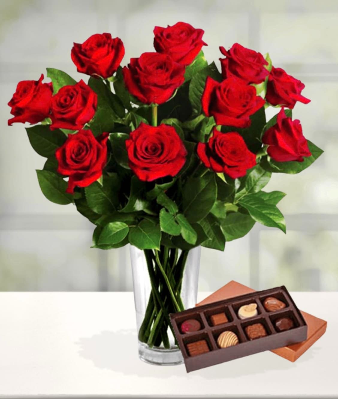 Dozen Red Roses & Chocolates Dozen Red Roses & Chocolates - A classic gift from the heart, our stunning bouquet of one dozen red roses is a grand gesture of love and affection. Paired with a delicious box of chocolates, this gift is one to wow. Item pictured is a depiction of an arrangement that we will make as similar as possible with the same look and feel.