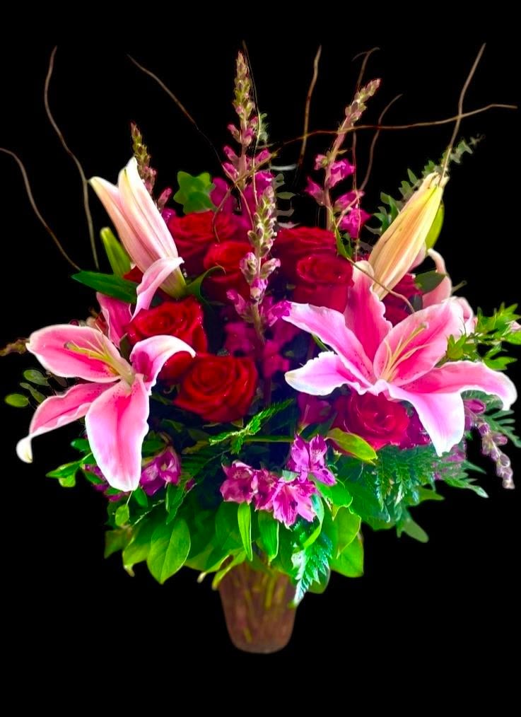 Splendor  - Composed of Stargazer Lilies, Pink Roses, White Alstroemeria, Waxflower, and various lush foliage. Decorated delicately with matching ribbon, set in a clear glass vase, and accented with your choice of decorative picks. This arrangement measures approx. 20&quot; W x 27&quot;H. This design can be created in various colors. Deluxe design pictured.