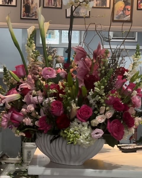 Love is in the air - Stunning arrangement of The most beautiful and precious blooms in pinks With the touch of white, In a beautiful modern ceramic container