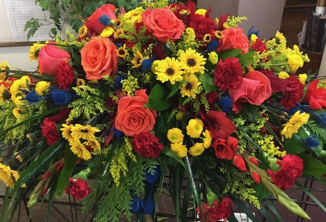 Celebration of Life Casket Piece Celebration of Life Casket Piece - Everlasting radiance and eternal remembrance. Bright yellows and oranges with robust reds, blues and greens.