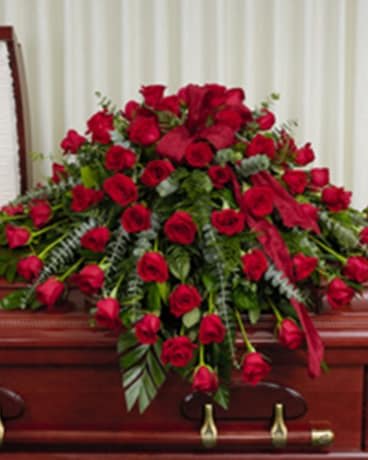 Overflowing Red Casket Spray - Picture reflects premium  price.  STANDARD 25- ROSE CASKET SPRAY  DELUXE   50 - ROSE CASKET SPRAY PREMIUM 75 - ROSE CASKET SPRAY 