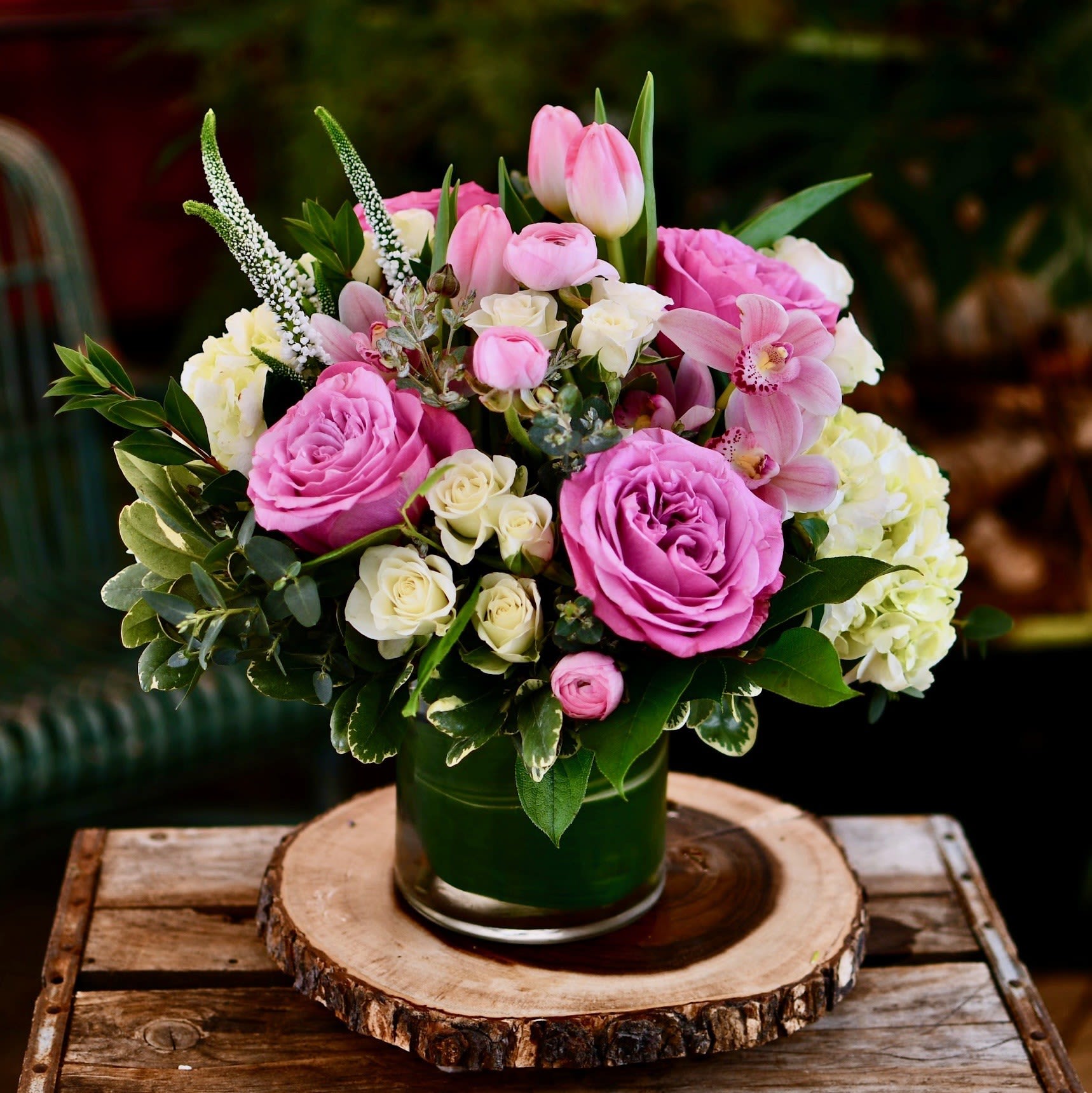 Garden Theme - Inspired by gardens filled with beautiful flowers, this arrangement features a mix of bold and delicate lavender, pink, and white flowers. Sure to bring a smile to any flower lover's face. Flowers subject to change based on availability, but will follow the color and feel. 