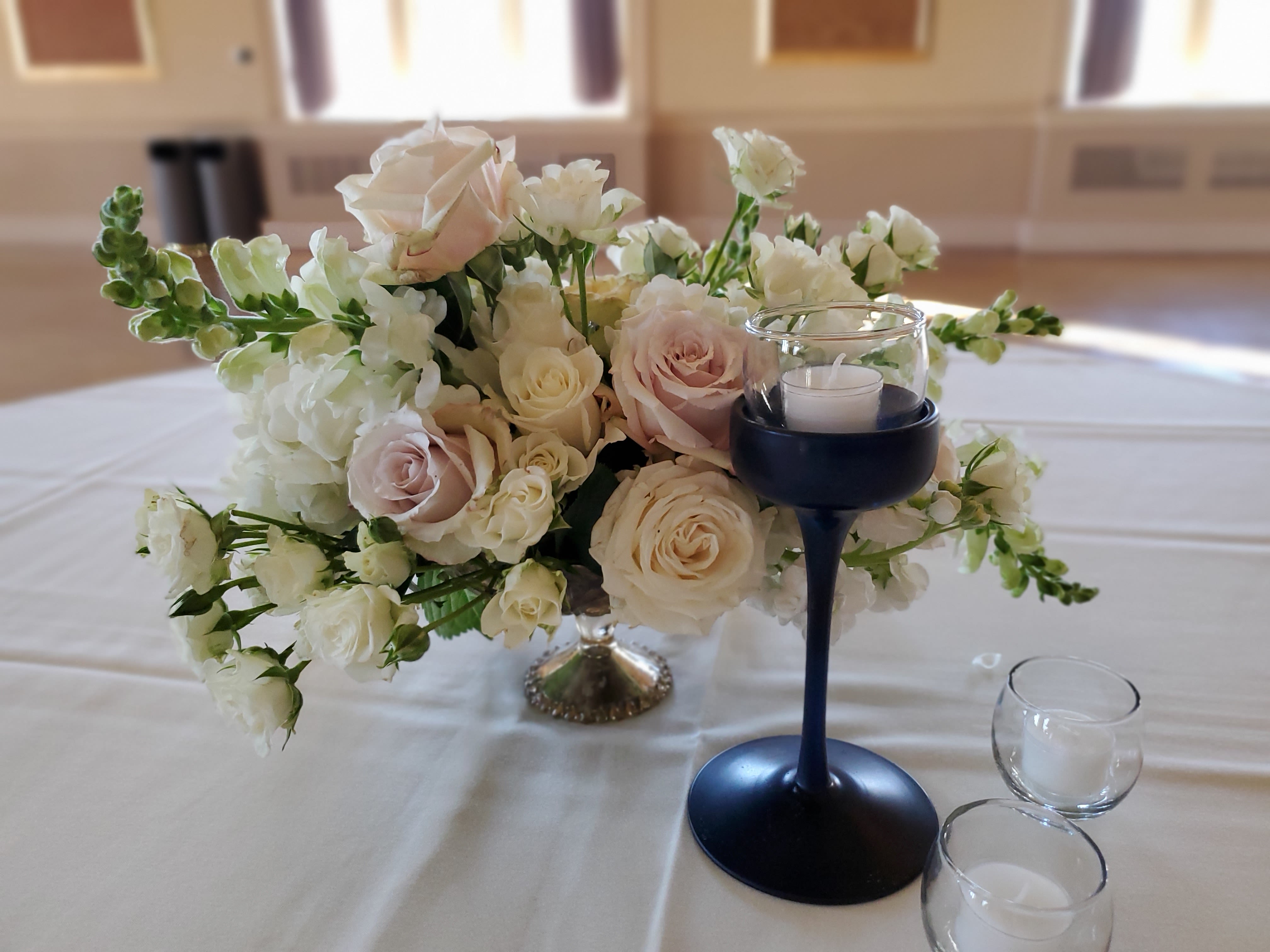 Candlelight  - Candlelight toned florals highlight this elegant centerpiece. Perfect for any special occasion or just because.  Made in a beautiful pedestal vessel. 