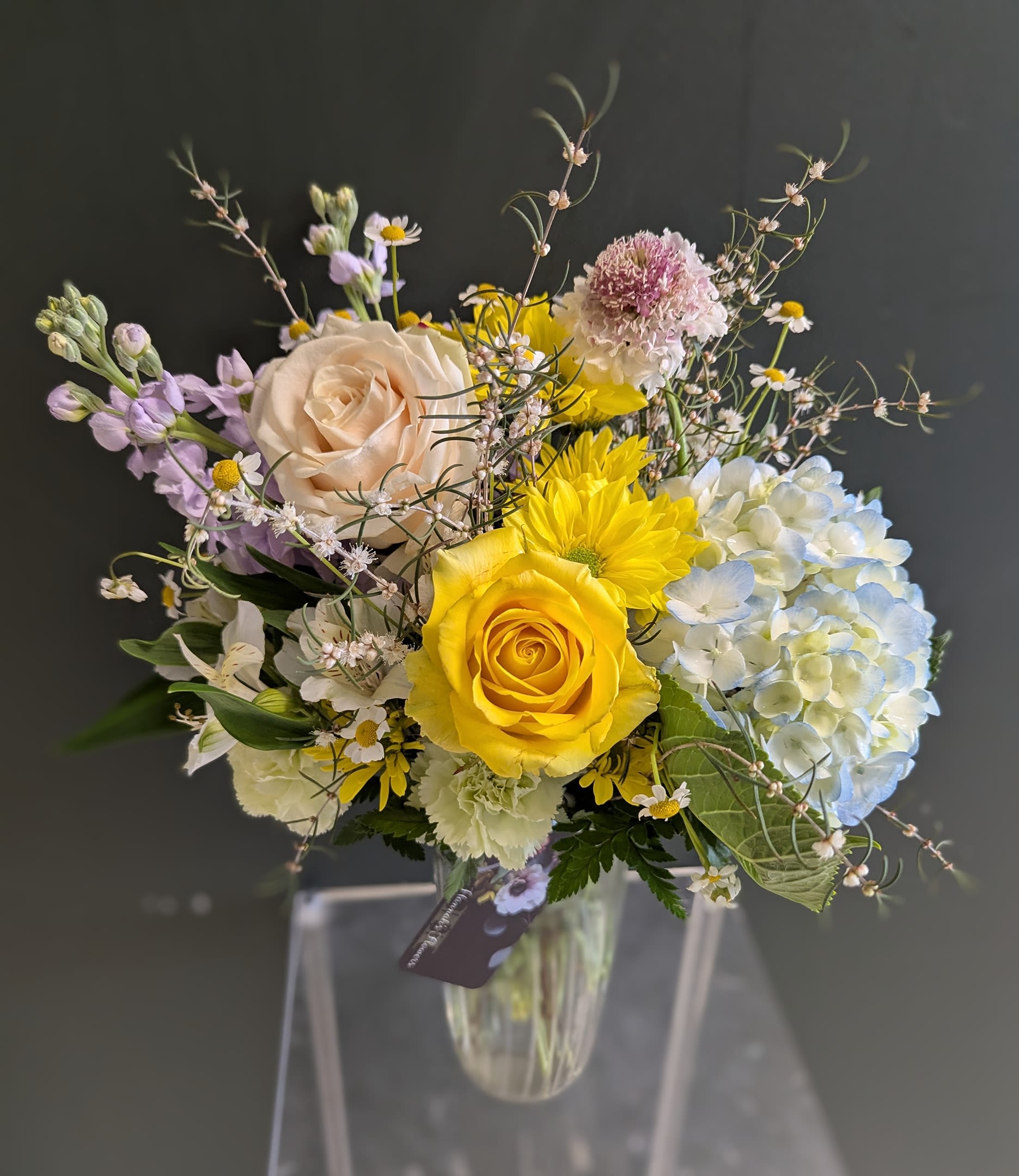 Cute Spring Mix Cute Spring Mix - This vase offers a whimsical Springtime feel and gives a long lasting impression. Each vase will contain the best of what the current Spring season has to offer us!