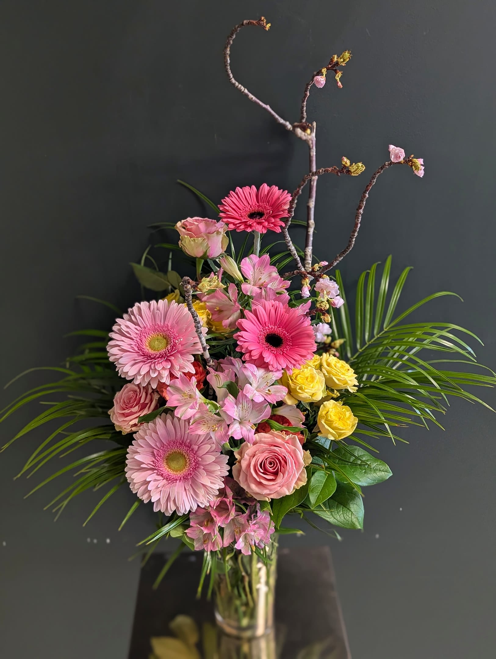 Soft Styled Vase Arrangment Soft Styled Vase Arrangment - Tired of the round vase arrangements? Are you seeking something with a bit more flair? Why not try out one of our "Soft Styled Vase Arrangements"? This vase is a half step between round lush vases and exciting high style pieces. This fusion is a great choice for any individual who has a little bit of edge or for someone who enjoys unique structure and balance!