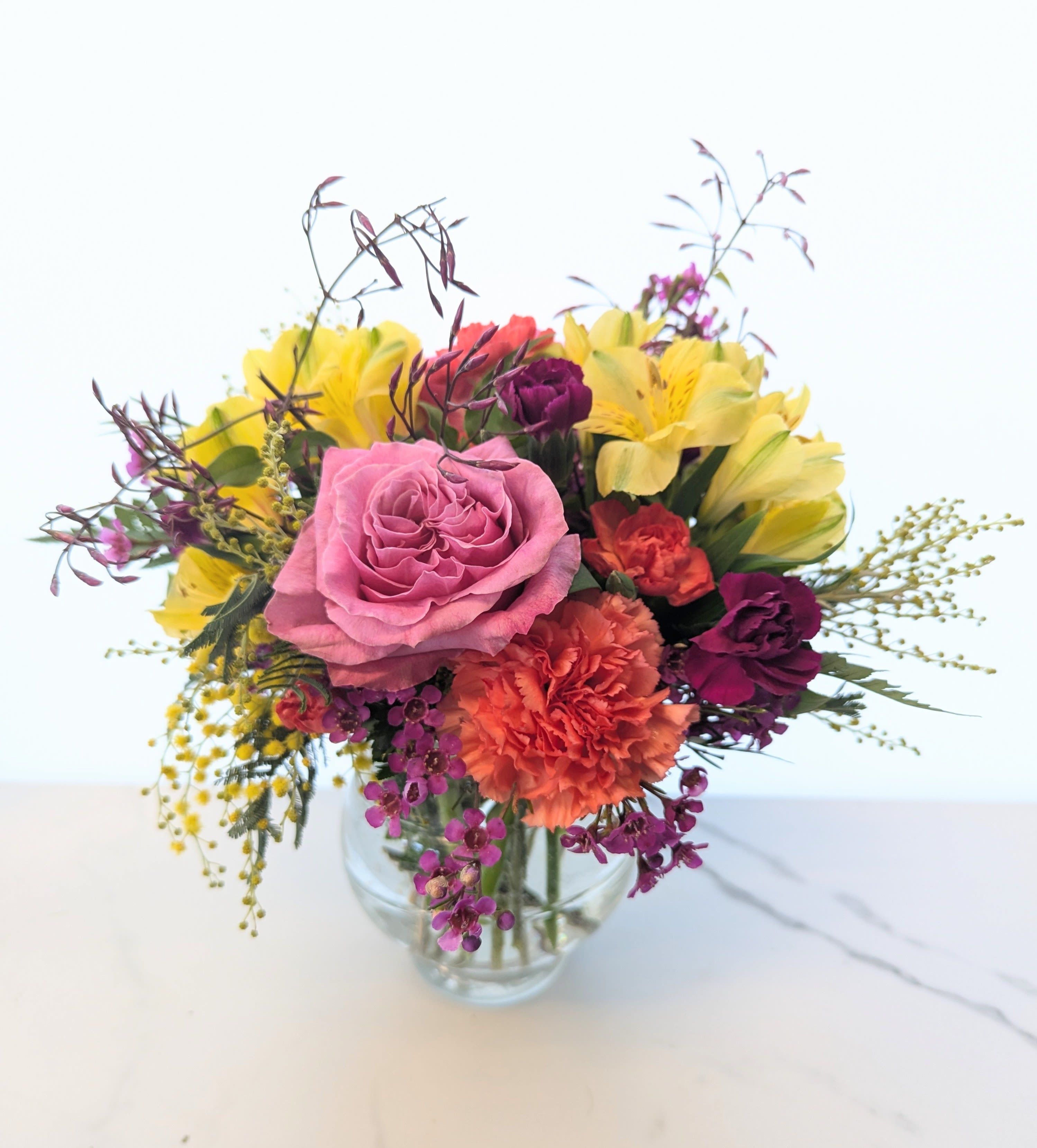 Small Bold Vase Arrangement Small Bold Vase Arrangement - What do you send when you are not sure what to send? How about a mixed arrangement filled with bold colors and long lasting blooms?
