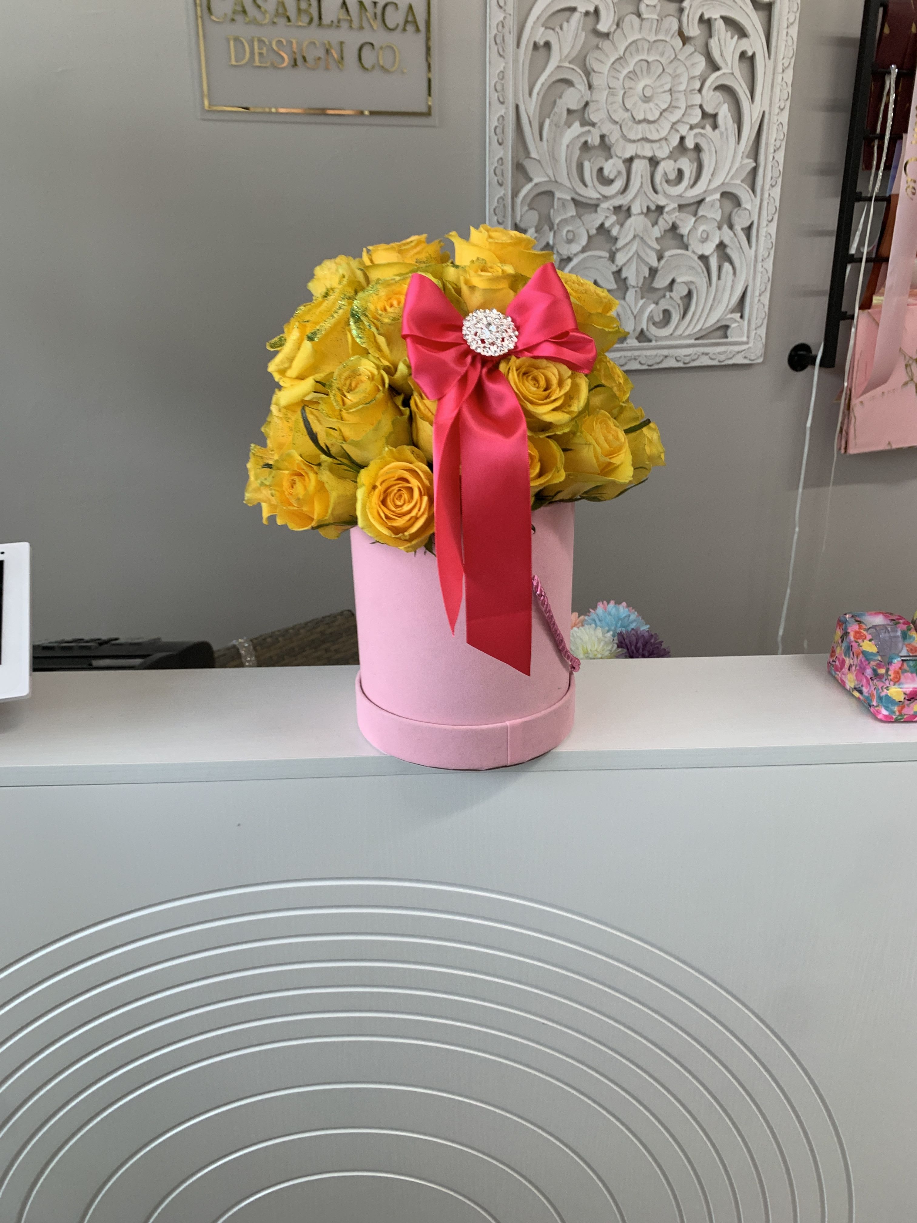 Aurora  - Yellow roses in a pink box with a hot pink ribbon. 