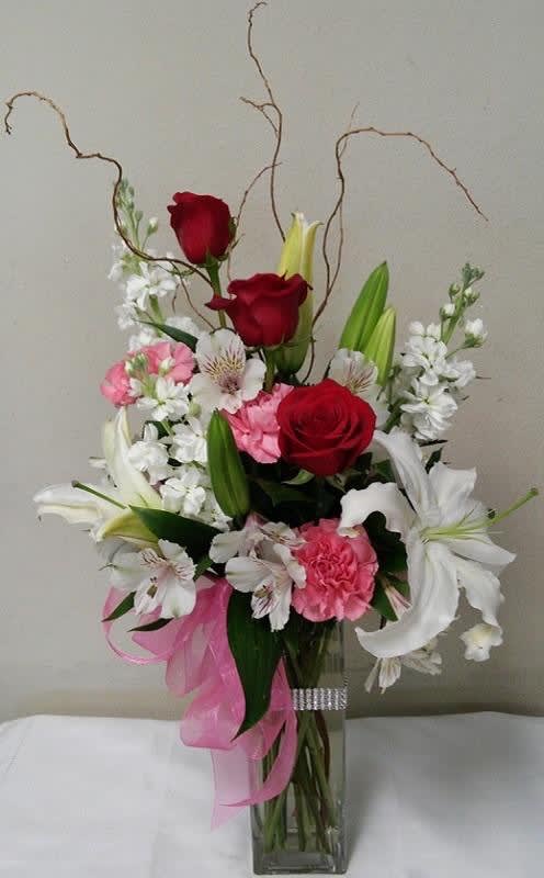 Roses and Lilies with Diamonds Roses and Lilies with Diamonds - Red roses, white oriental lilies, white stock pink carnations with white alstroemeria greens and bow. *Deluxe Shown