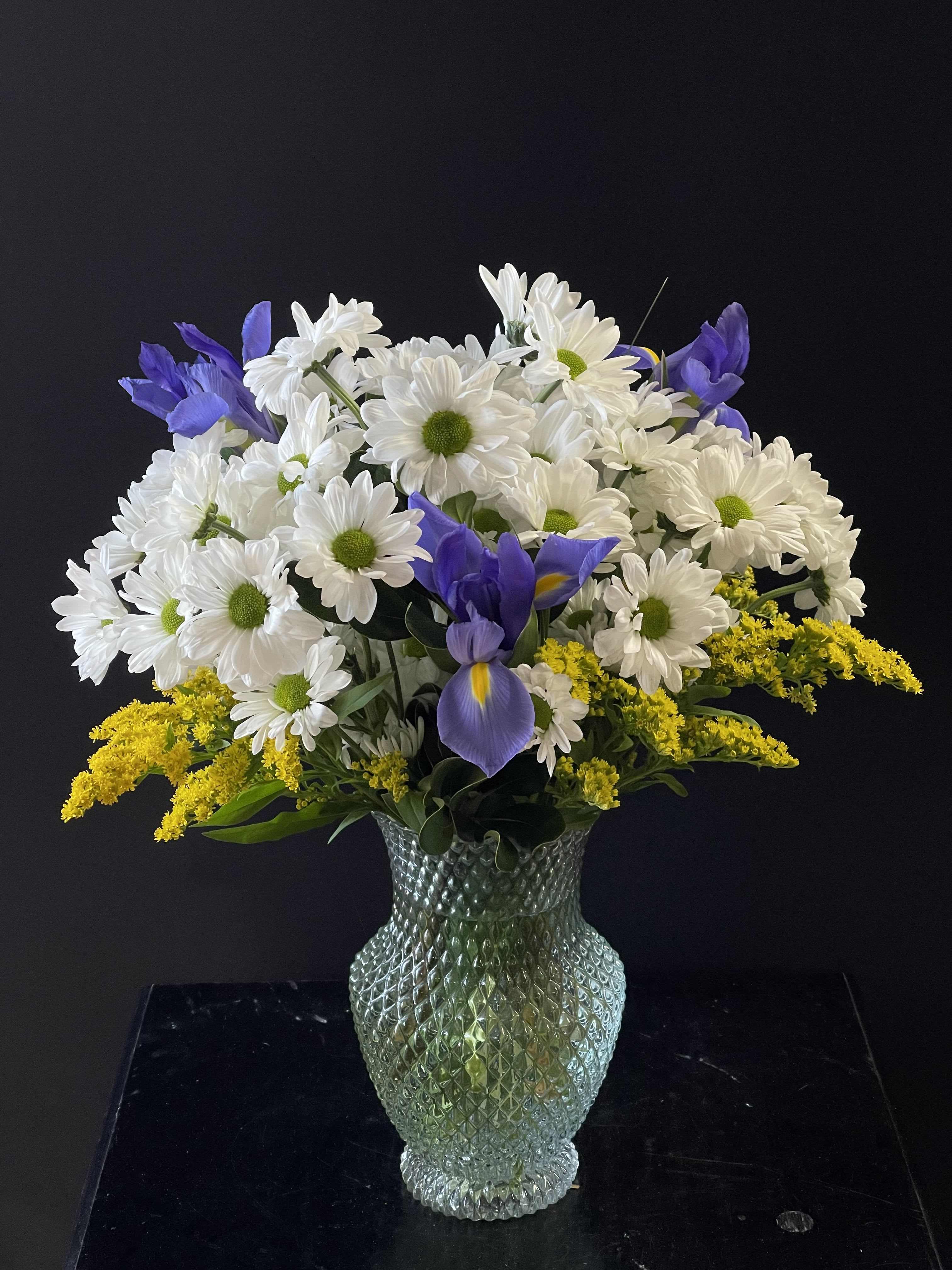 For the Love of Daisies  - A mint green vase full of daisies and blue iris.