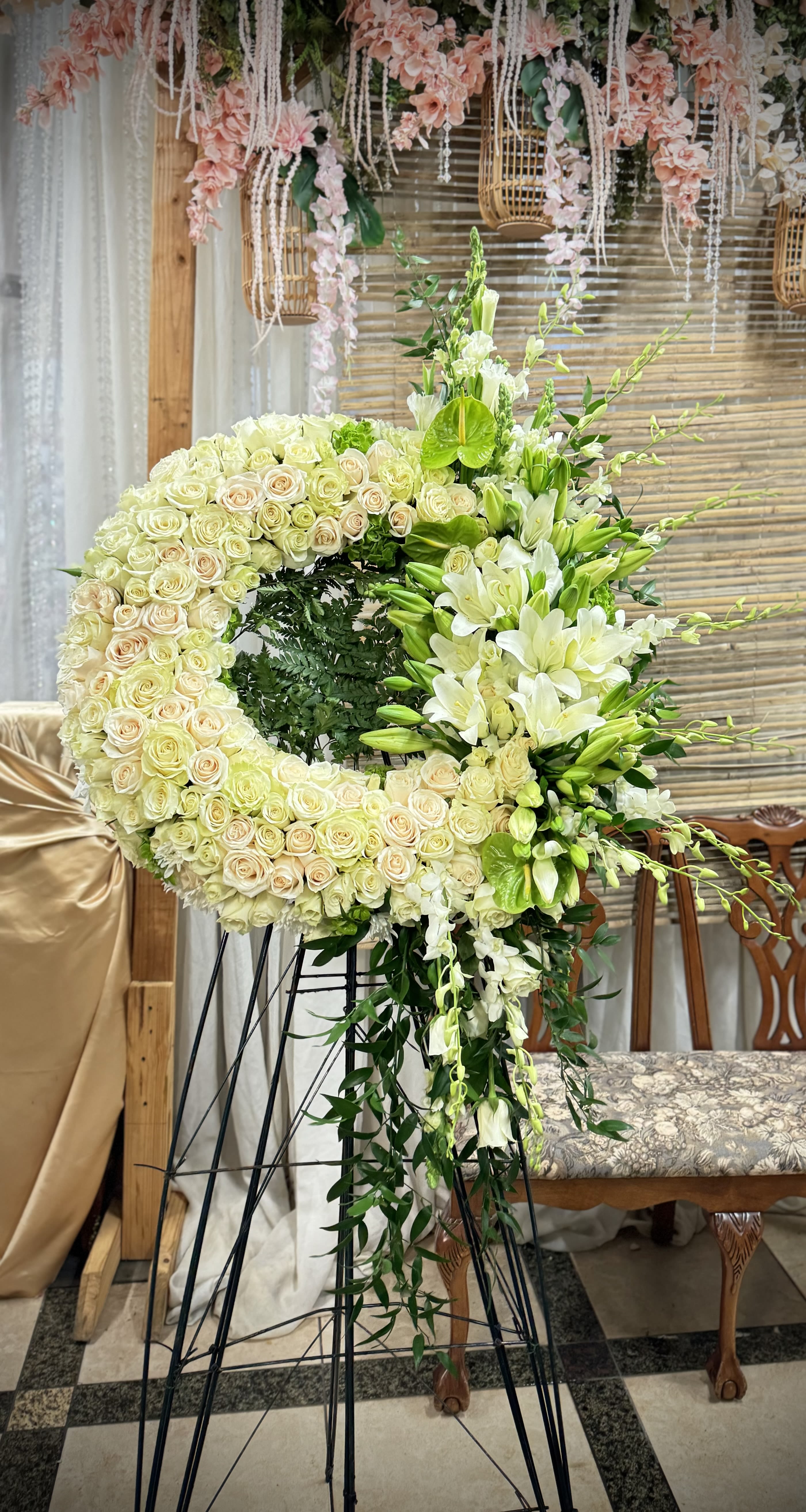 Wreath Stand #4 Wreath Stand #4 - An elegant wreath arrangement crafted with care, symbolizing eternal love, peace, and respect. Perfect for honoring the memory of a cherished loved one and offering comfort during times of loss.