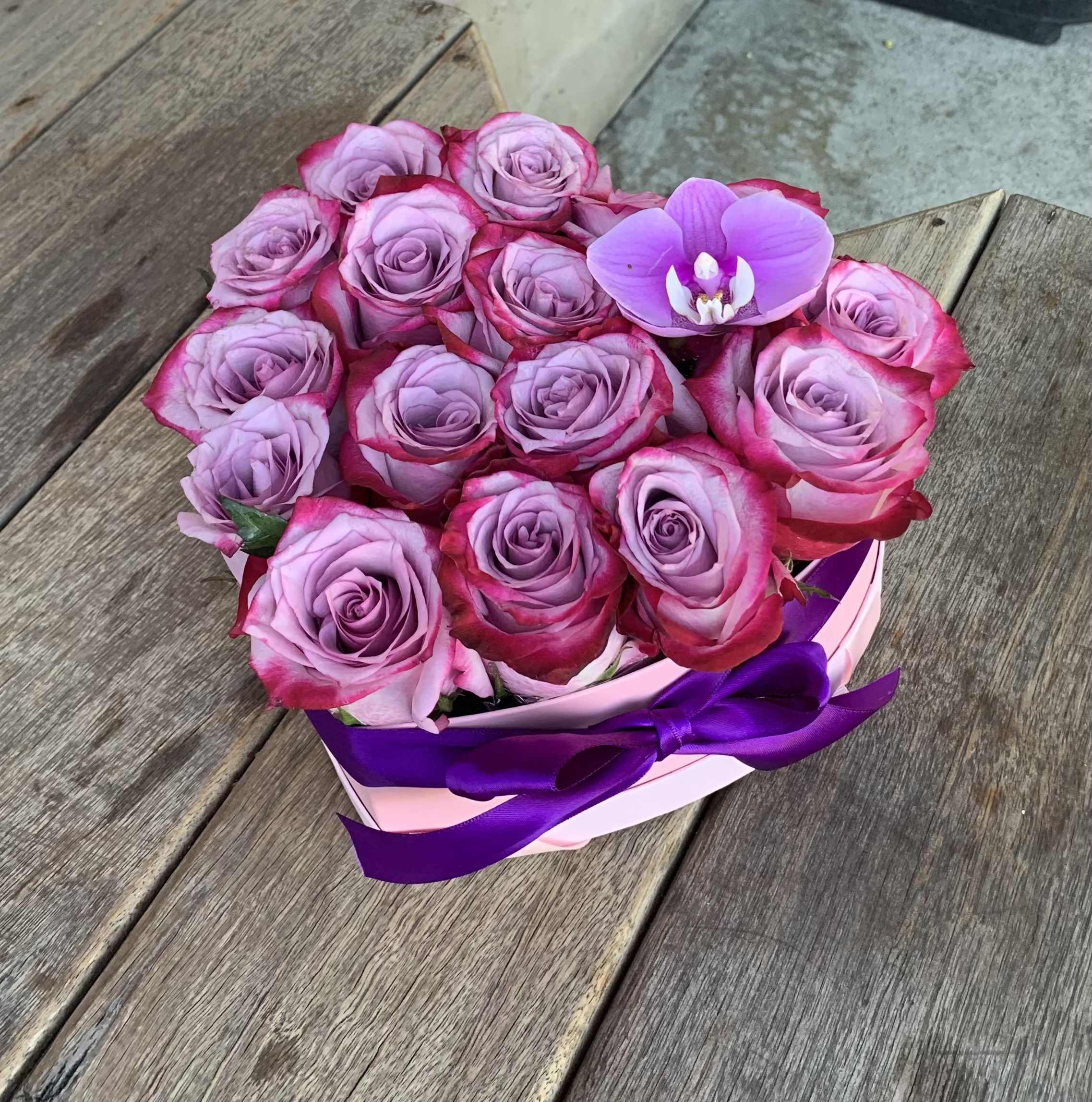 Heart Shaped Box of Roses Heart Shaped Box of Roses - Take this purple rose heart shaped box home with you today! Filled with amazing purple roses imported from Ecuador carefully situated to resemble a heart. It is perfect for loved ones!