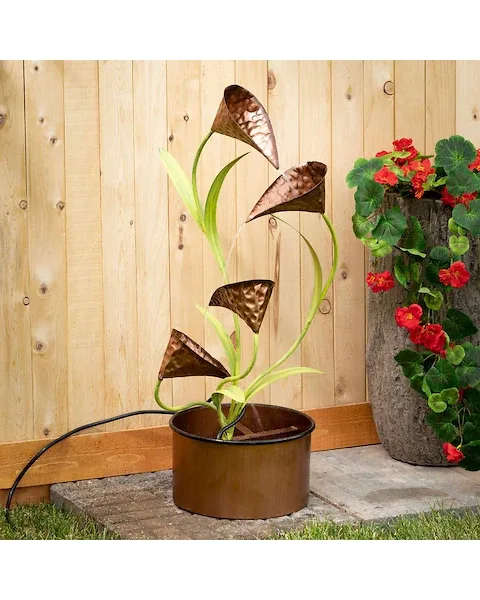 Copper Water Lily Fountain - This sculptural masterpiece is truly a sight to be seen! A simple round basin foundation serves as the ideal base for this flowing water feature. Brushed with vibrant copper highlights, the naturally winding stems are capped with stunningly delicate cala lilies. Exclusive: Yes Dimensions: 11&quot;L x11&quot;W x32&quot; Weight: 3.0lbs 5.00oz Color: Copper Material: Metal Outdoor use: Yes