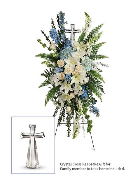 Eternal Grace Spray With Crystal Cross Included - A touching display of devotion, this peaceful spray of white and light blue flowers is accompanied by an elegant crystal cross keepsake that will be cherished for years to come. This serene spray includes blue hydrangea,crème roses, white asiatic lilies, white alstroemeria, bells of Ireland, blue delphinium, white snapdragons, myrtle, sword fern, leatherleaf fern, spiral eucalyptus, and variegated pittorsporum. Delivered on a wire easel with a Large Crystal Cross Keepsake.