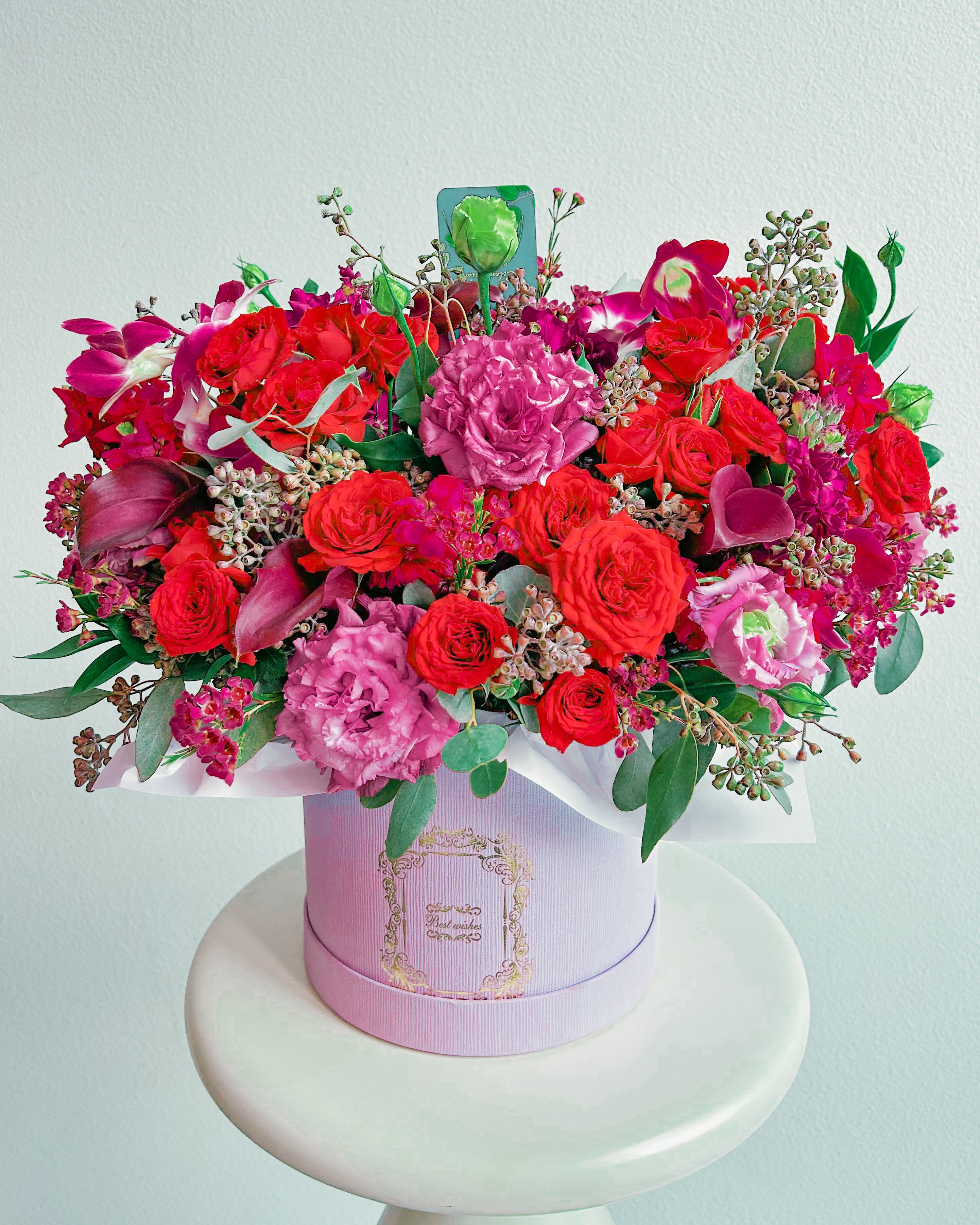 Lavish Love - This ain’t just a bouquet—it’s an energy. Deep red roses that scream passion, soft lilac blooms dripping with elegance, and a touch of wild orchid chaos. Wrapped in a sleek, pastel hatbox, this floral arrangement is pure luxury with an edge. Whether you’re making up, leveling up, or just flexing on ‘em—this is the floral equivalent of a designer fit. L.A. doesn’t do basic. Neither should you.