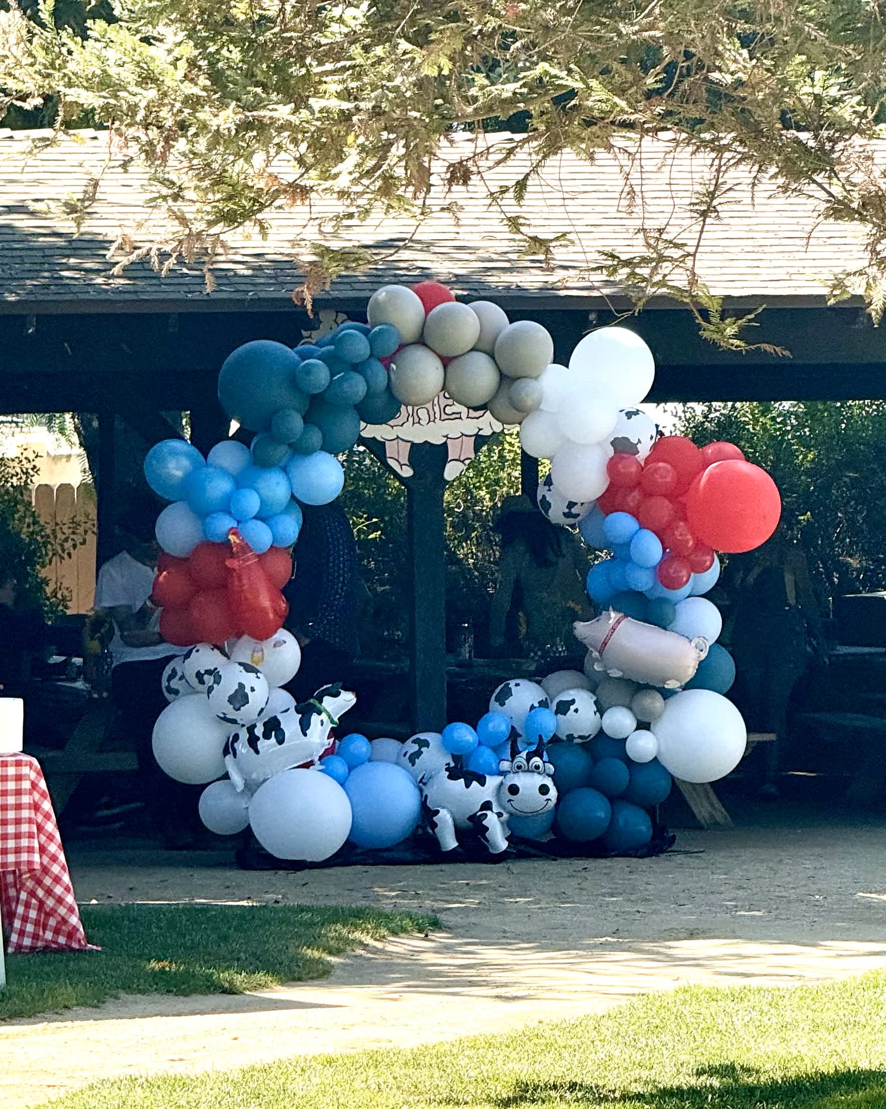 Country Farm Celebration Country Farm Celebration - The "Country Farm Celebration" balloon arch brings the charm of the countryside to your event with a delightful farm theme. Featuring a vibrant mix of blue, beige, and red balloons, and accented with adorable farm animal figures, this arch creates a playful and welcoming atmosphere. Ideal for children's parties, farm-themed gatherings, or rustic celebrations, the "Country Farm Celebration" adds a touch of whimsical fun and nostalgic appeal, making it a memorable centerpiece for your festivities.