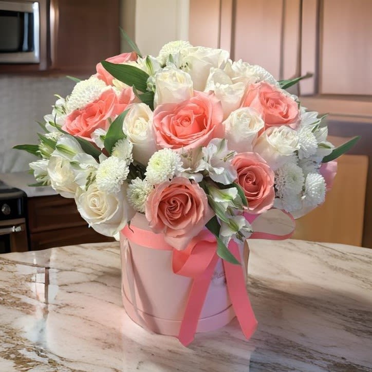 Luxury Pink &amp; White Rose Hat Box Bouquet - Delight your loved ones with this stunning pink and white floral arrangement, elegantly presented in a chic hat box. Featuring fresh blush pink and ivory roses, accented with delicate white chrysanthemums and lush greenery, this bouquet exudes sophistication and charm. Perfect for birthdays, anniversaries, romantic surprises, or just because! Handcrafted with premium blooms, this luxury flower arrangement adds a touch of elegance to any setting. Available for same-day flower delivery in Los Angeles. Order now and make every moment special!