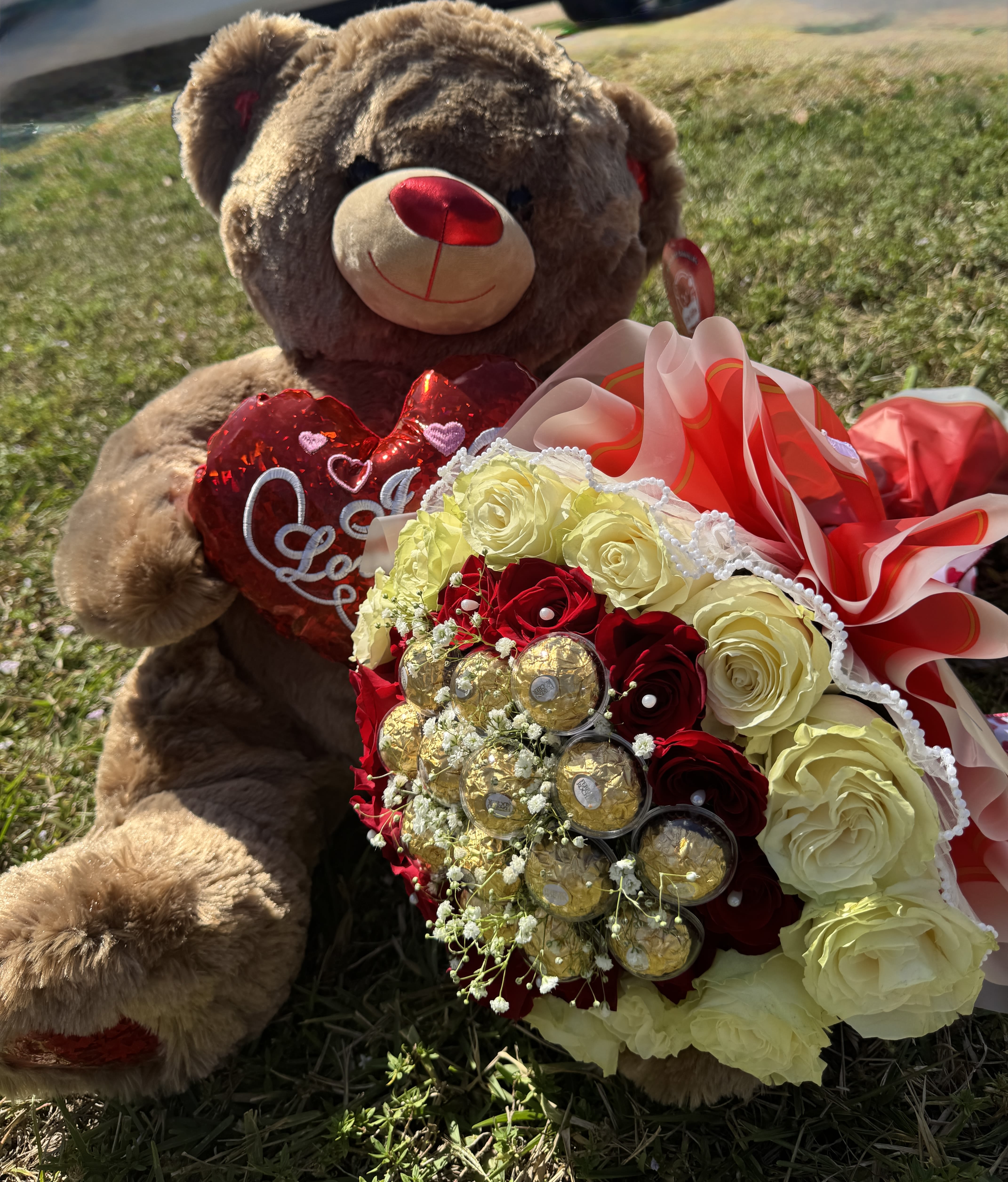 Love Teddy  - A perfect and elegant bouquet that combines the breathtaking beauty of stunning roses with the indulgence of delicious chocolates, all beautifully paired with an adorable large teddy bear. This charming arrangement is the ultimate gift to convey love, warmth, and affection on any special occasion, creating a memorable and heartfelt moment.  Includes:  Gorgeous roses  Premium chocolates  A cuddly, oversized teddy bear