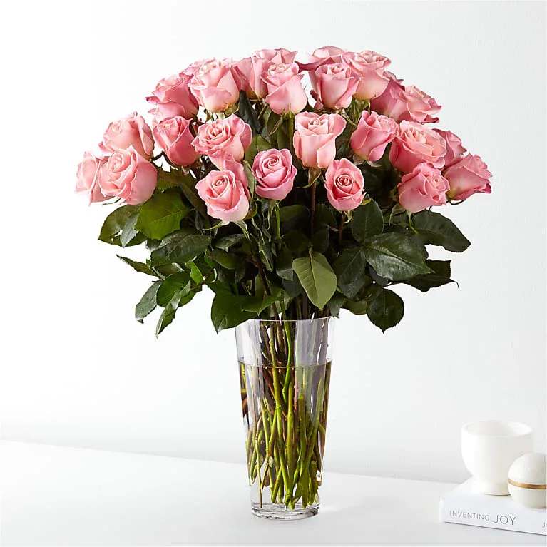 3 Dozen Long Stem Pink Roses - Step right up, dear friends, because Irvine Village Flowers has a story to tell that’s blooming with love and elegance! Imagine a bouquet so enchanting it’s practically made for the classic souls among us—three dozen premium pink roses, each one a little burst of joy and romance, ready to steal the show and warm every heart.  Picture this: thirty-six stunning pink roses, their soft, blush petals unfurling like a love letter written just for you. These beauties are gathered together in a glorious arrangement that’s as luxurious as it is heartfelt, delivered straight from our flower-loving hands at Irvine Village Flowers. These aren’t just any roses—they’re premium, picked for their charm and longevity, and they whisper sweet meanings of love, gratitude, and admiration with every delicate bloom. It’s the perfect way to tell your soulmate, your bestie, or even yourself, “You’re absolutely cherished!”  Let’s dive a little deeper into these rosy wonders. Pink roses have a magic all their own—think timeless beauty with a modern twist. Their gentle hue is a nod to appreciation and affection, making them ideal for any occasion that calls for a little tenderness. With three dozen in the mix, this bouquet is a grand gesture that keeps on giving, thanks to their fabulous vase life and irresistible allure.