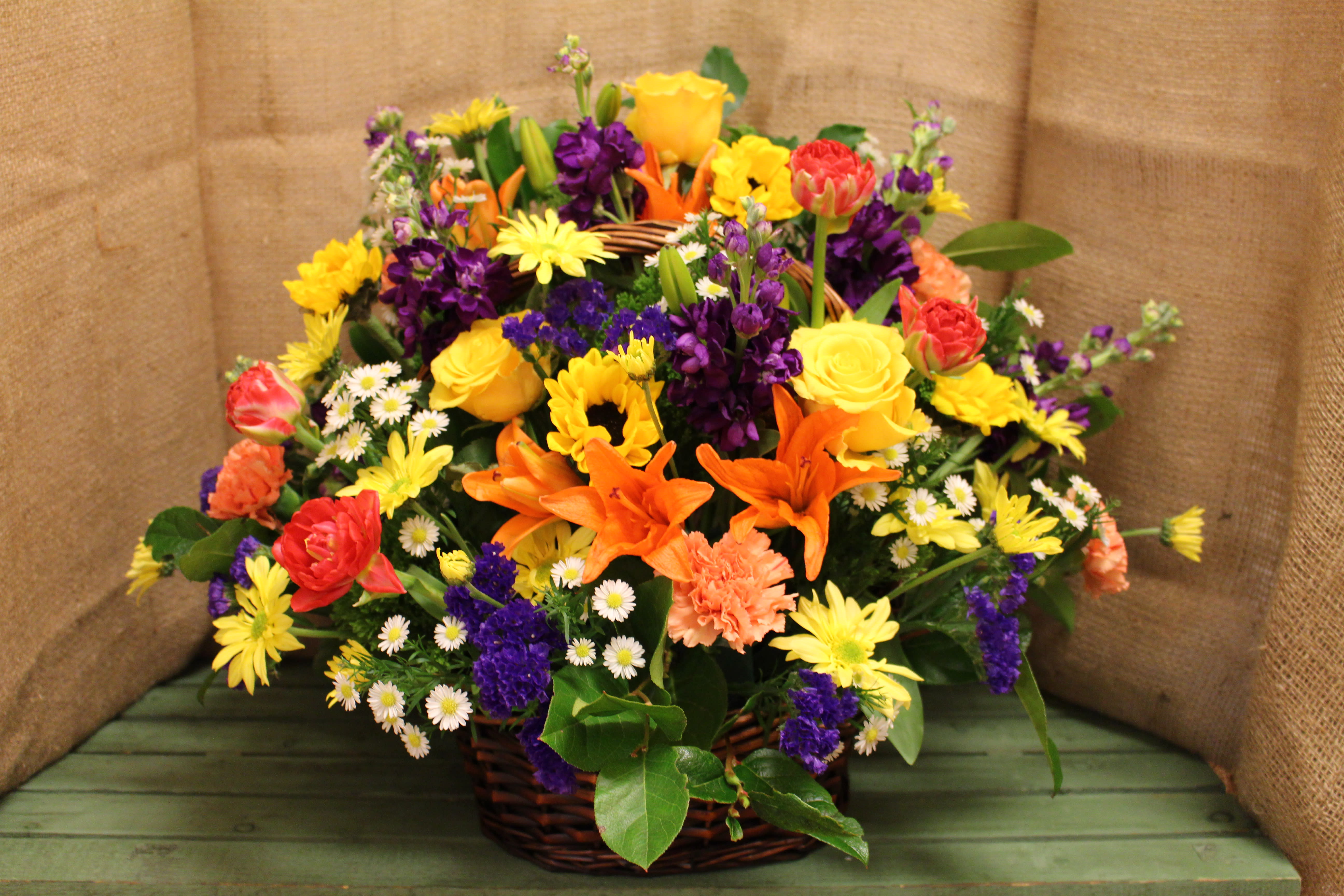 Bursting &amp; Bright Basket  - A vibrant mix of flowers to honor a loved one's life. With bright colors to uplift spirits while reflecting on cherished memories, this arrangement is the perfect size for services and can also be taken home by family members.  