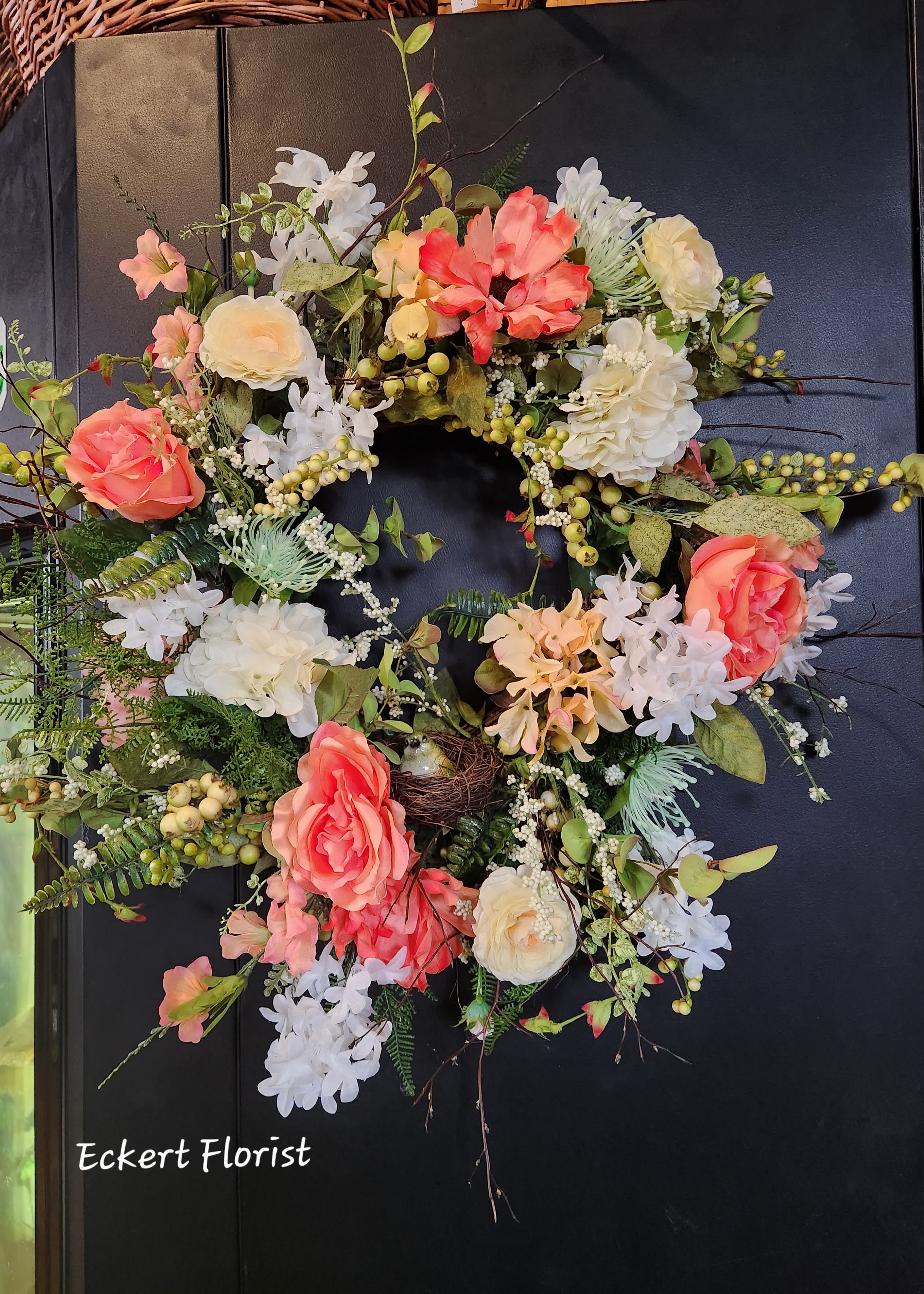 Eckert Florist's Artificial Peach and Ivory Wreath *Our Local Delivery Only Eckert Florist's Artificial Peach and Ivory Wreath *Our Local Delivery Only - This artificial wreath would be perfect for any decor. Approx. 27" diameter Colors: Peach, White, Ivory, Green. Flowers and colors may vary.