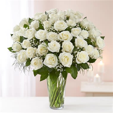 Ultimate Elegance™ Long Stem White Roses - Our striking long stem white roses are the ultimate way to show you care. Four dozen pure white blooms are artistically arranged by our expert florists inside an elegant glass vase and personally hand-delivered to help you express how you feel straight from the heart. All-around arrangement with 48 long stem white roses; accented with baby’s breath and assorted greenery Our florists select the freshest flowers available, so shade of rose may vary due to local availability Artistically arranged in a classic clear glass vase 48-stem arrangement measures approximately 23&quot;H x 18&quot;L