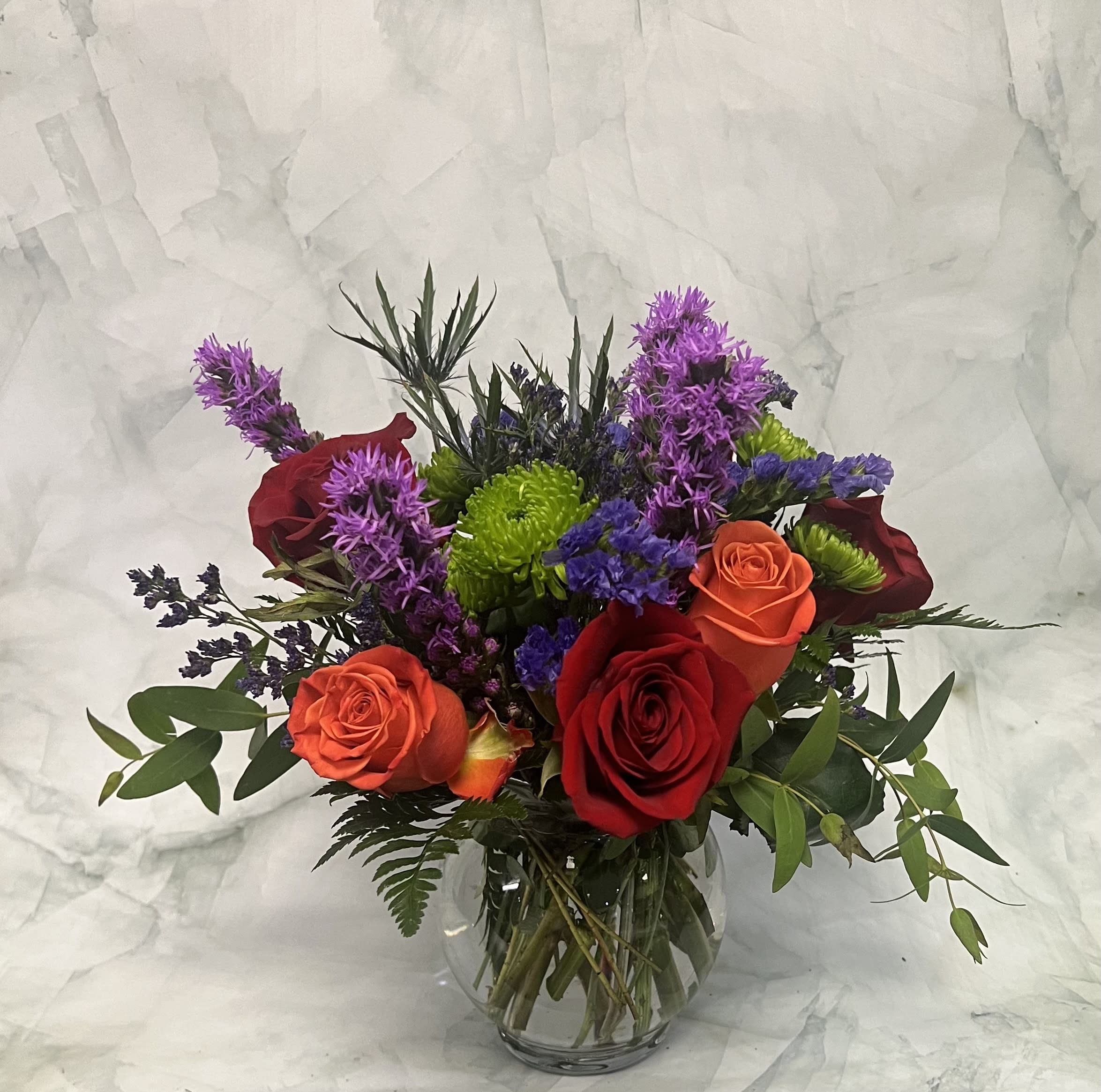 Celebration Bowl Celebration Bowl - This bowl of flowers is truly celebratory! You can celebrate life and any occasion life has to offer. There are tons of color in this funky arrangement. This is perfect for the one in your life that doesn’t like the typical floral arrangement. Send something fun and exciting. This arrangement is arranged in a fish bowl and makes a great centerpiece. It includes Roses, Liatris, Thistle, Mums, Statice and assorted greens.