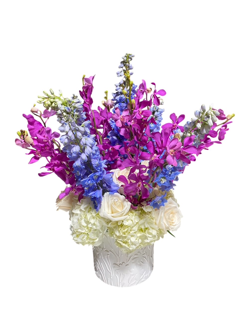 Kaleidoscope  -  The Tropical Bouquet is a stunning arrangement that embodies the beauty of exotic blooms and classic elegance. This lavish bouquet features vibrant tropical orchids, delicate roses, majestic delphinium, and lush hydrangea meticulously arranged to create a masterpiece of sophistication and charm. Each bloom complements the other perfectly, creating a harmonious blend of colors and textures that exude luxury and grace. Perfect for any special occasion or to brighten up any space with its tropical flair and timeless beauty.