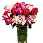 Momma's Boy Momma's Boy - Premium orchids, tulips, and roses in a glass vase. A gorgeous arrangement for that special woman in your life.