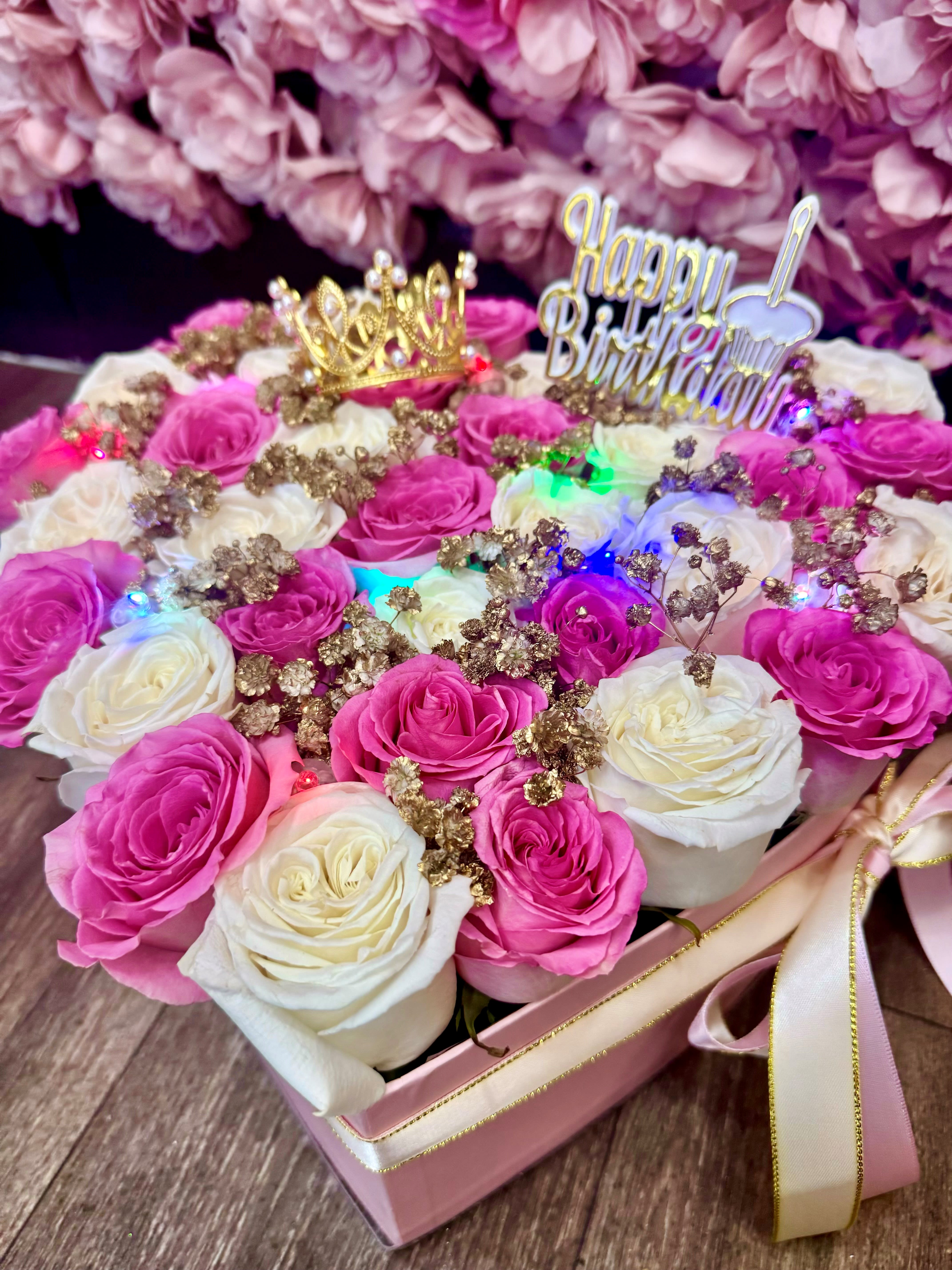 pink heart of gold  - pink or black shape box filled with white and light pink roses, with a pinch of gold baby breath. 