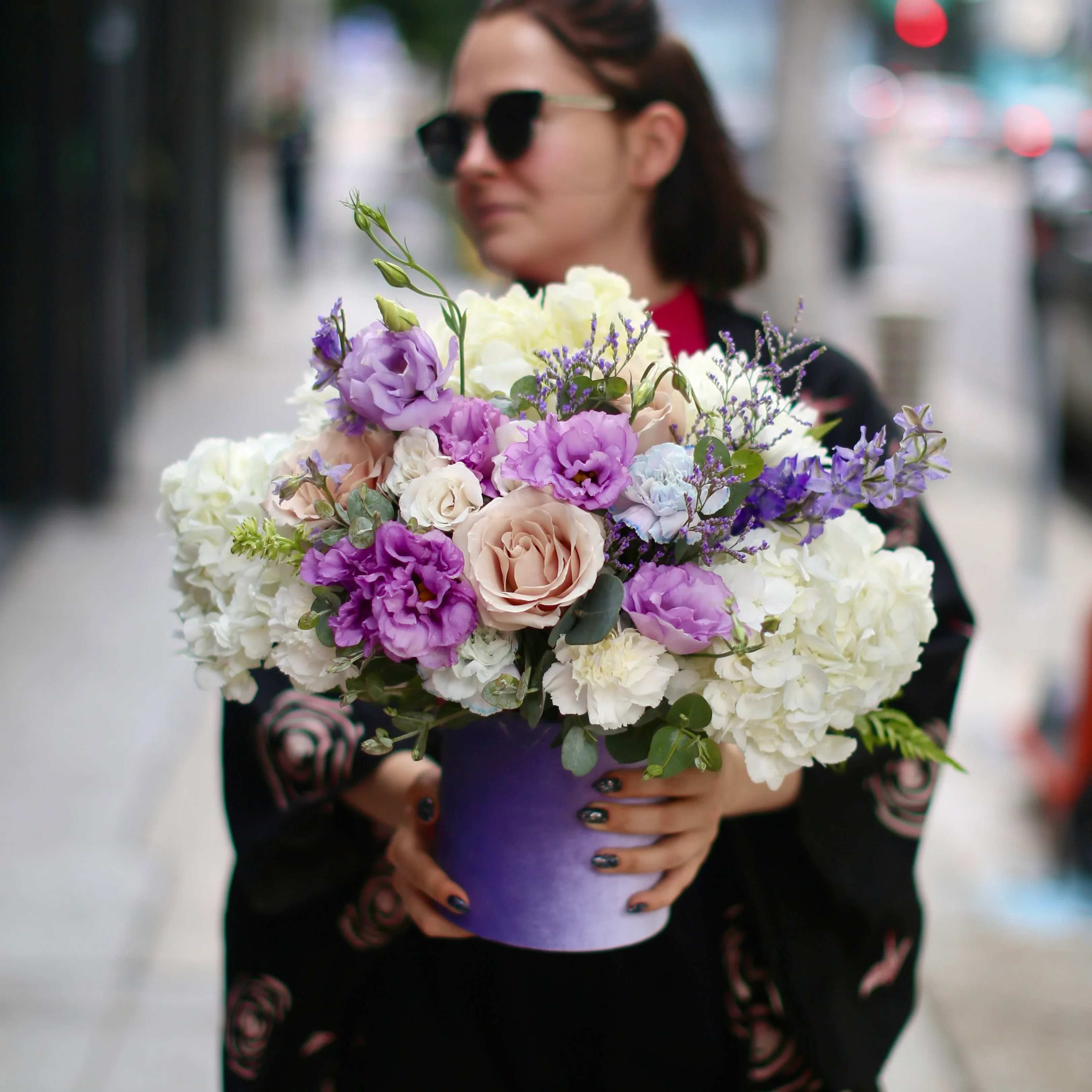 Enola - Enola is a gorgeous arrangement that consists of three sorts of roses in white shades with irises and dahlias. 