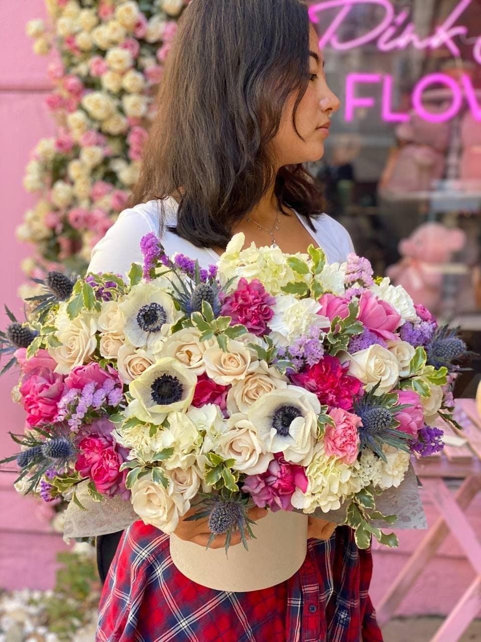Loli - Loli is a sunning arrangement of garden roses, carnations and eryngium flowers with white anemones or tulips has mainly pink or blue colors and comes in a box. 