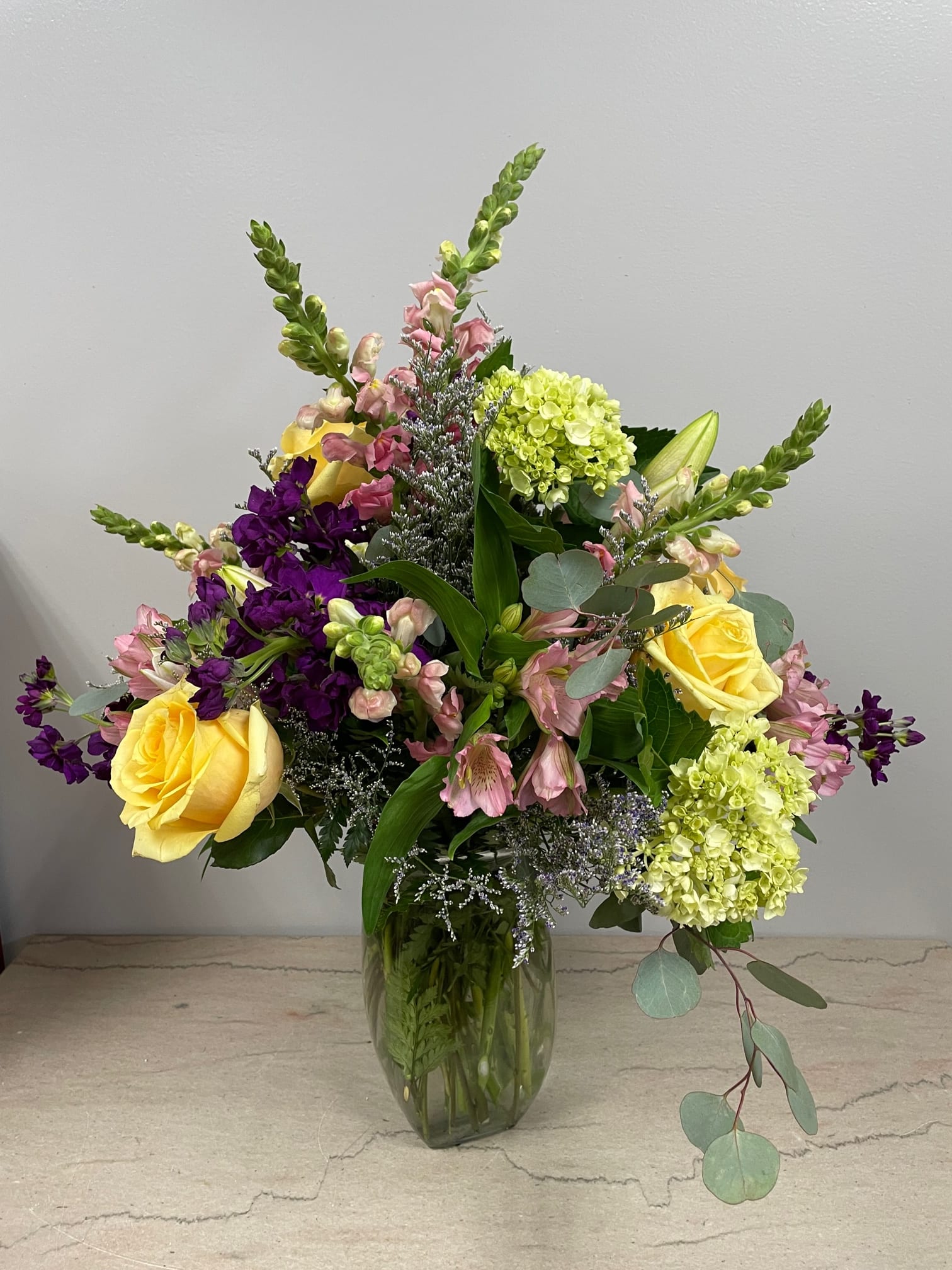 English Countryside English Countryside - Evoking images of cottage gardens in the Cotswolds, this lovely gathering of seasonal blooms including snapdragons and hydrangea looks as though it was just gathered from grandmother's garden. As Shown Deluxe*