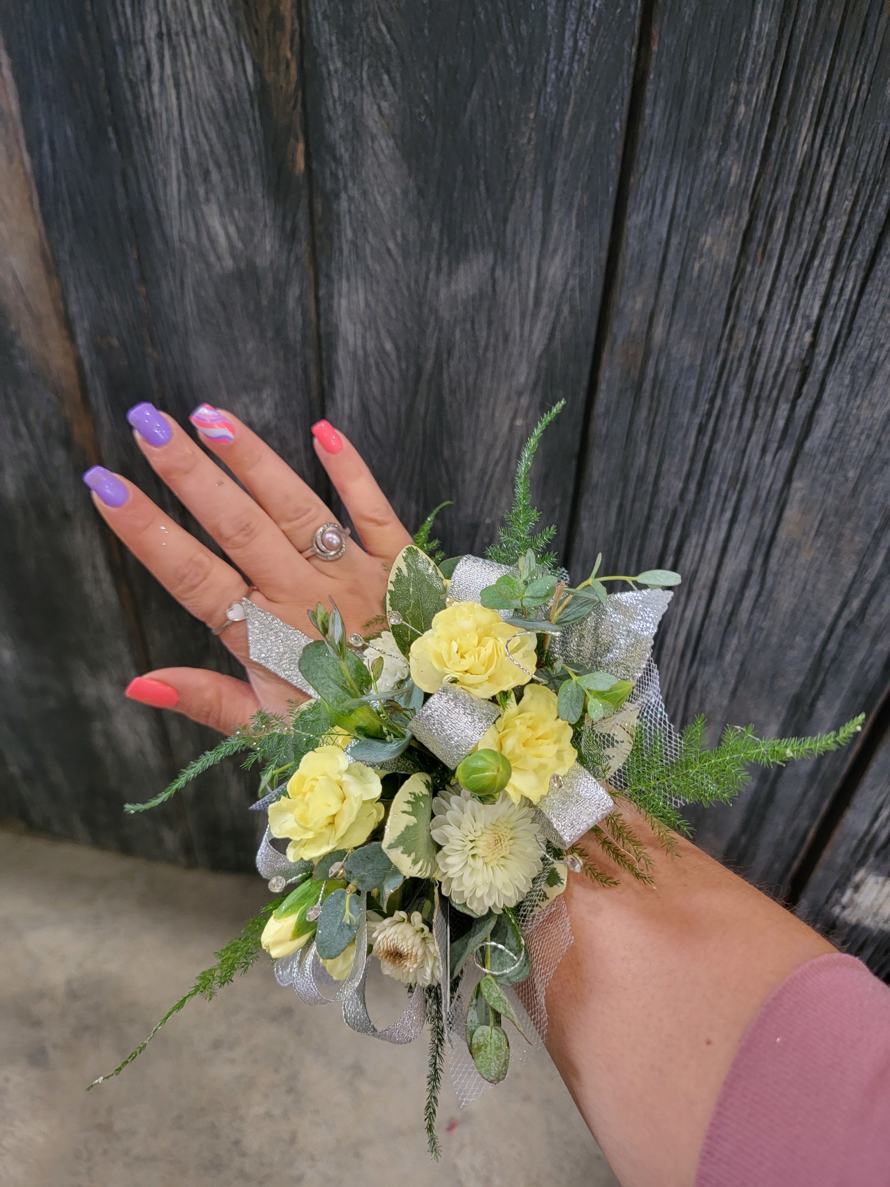 Yellow Corsage Yellow Corsage - A beautiful yellow corsage made with your choice of flowers. Options include: roses, mini carnations, alstromeria, daisies, or cushion mums Please include preferred flower type and accent colors in description of order! Or simply reply with designer choice! Deluxe pricing includes more flowers