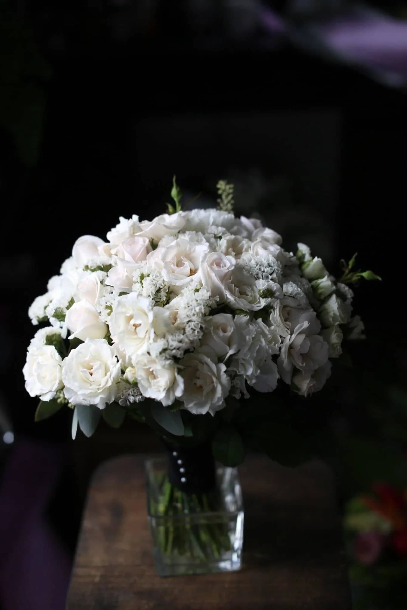 Ruby - White roses and carnations flowers create the best bridal bouquet.