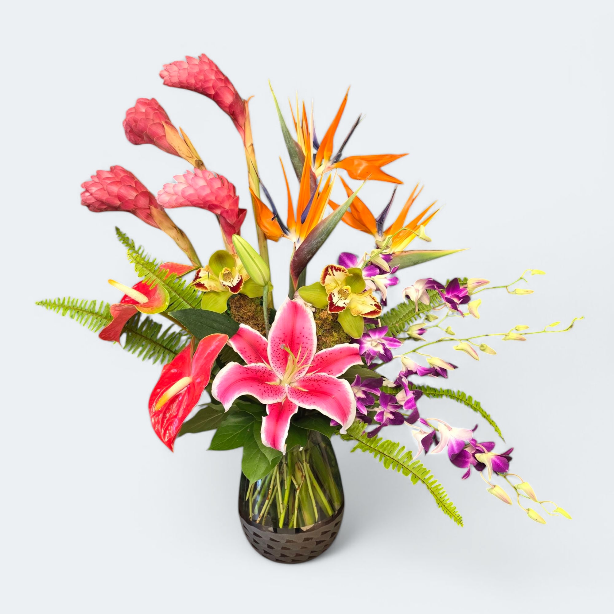 Leilani - A tropical mix of flowers including ginger, birds of paradise, cymbidium orchids, antheriums, dendrobium orchids and stargazer lilys with pops of fern. 