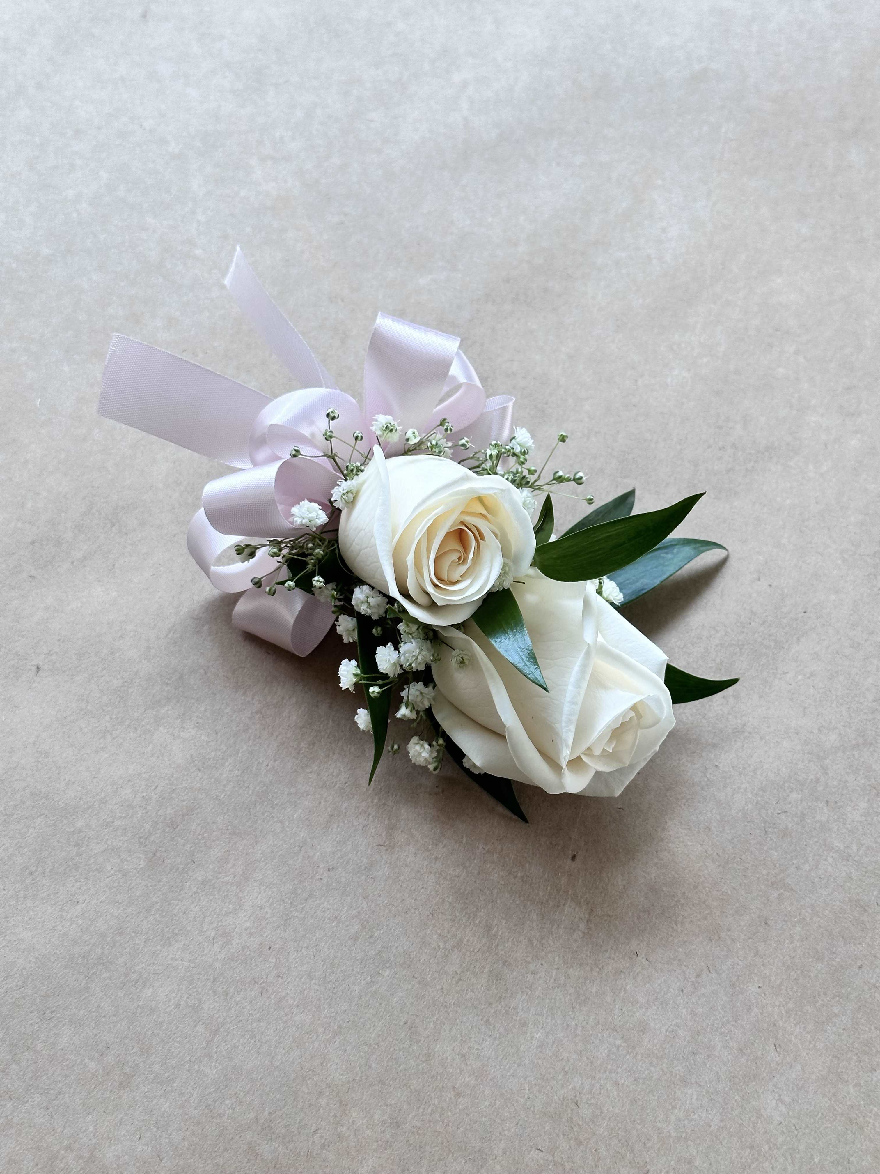 Two rose corsage  - A beautiful corsage with two roses, perfect for prom a wedding or any occasion. Could come In any colors.