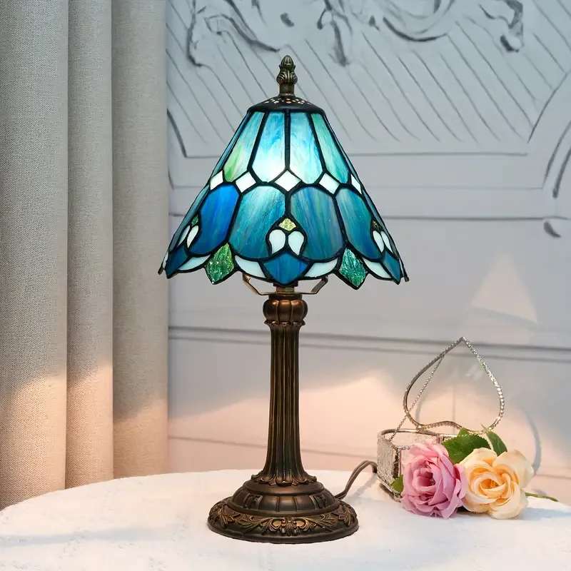 Blue Orchid Tiffany Style Memory Lamp Blue Orchid Tiffany Style Memory Lamp - Our Blue Orchid Tiffany Style -stained glass memory lamp features a beautiful tiffany glass shade with a cast resin base. Featuring a 5-foot cord with an on/off switch and uses a type B bulb. Max 40 Watts. Comes with card that reads, "This lamp was specially selected by (insert names), To honor the memory of (name or relation), Each time you light this lamp, may you recall the many wonderful occasions that you have shared together, and their light continues to shine and touch your life. With Deepest Sympathy." 8 Inch Diameter shade and 14.25 Inch Height