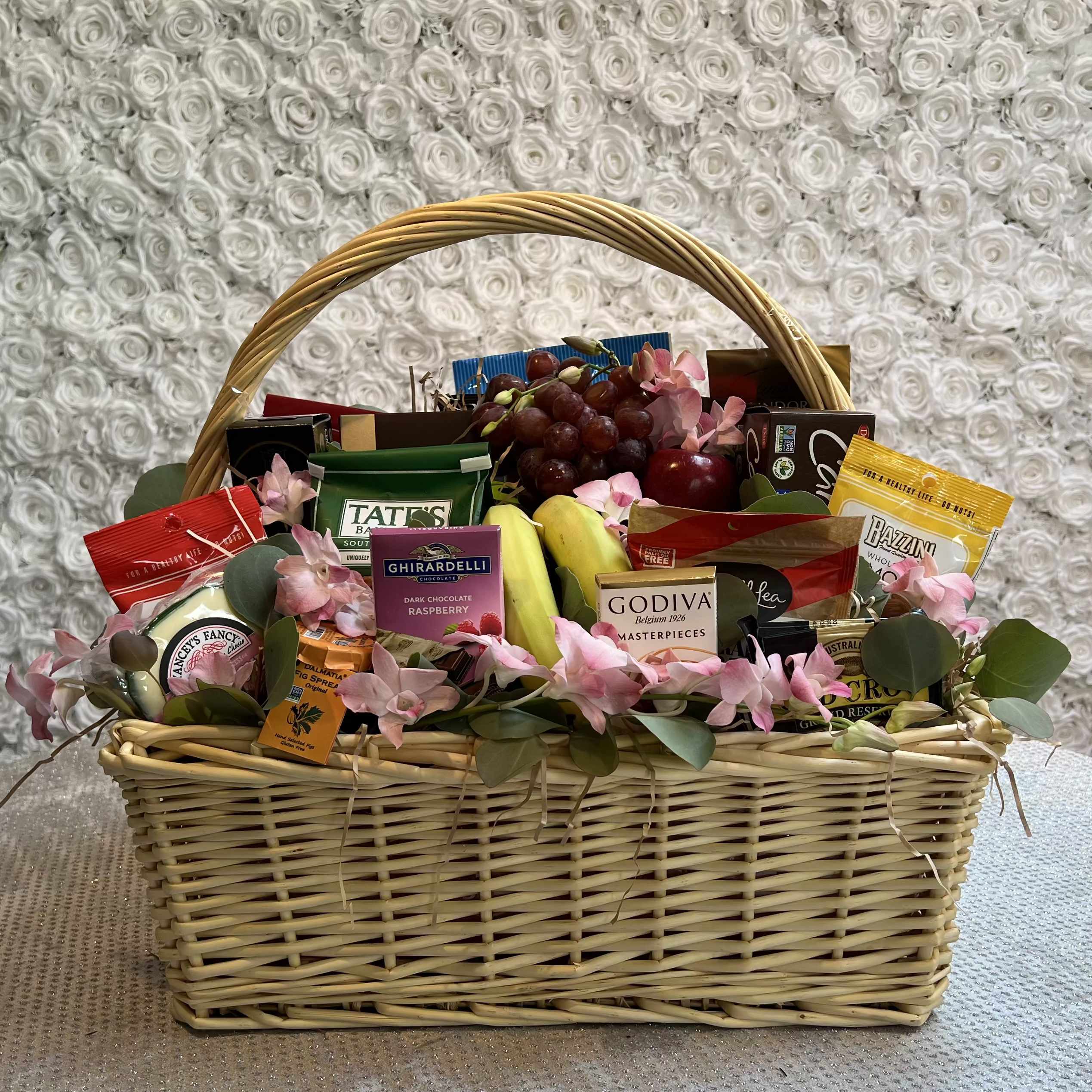 Luxury Taste Gourmet Basket Luxury Taste Gourmet Basket - This luxury gift basket is simply overflowing with goodies. It's sure to make a big impression on anyone from the boss to friends and family. It holds all kinds of fresh fruit - from apples and pears to bananas and oranges - gourmet chocolates and cookies, cheeses, sausages, crackers and more. Plus, it's all wrapped and ribboned in a big delightful basket.