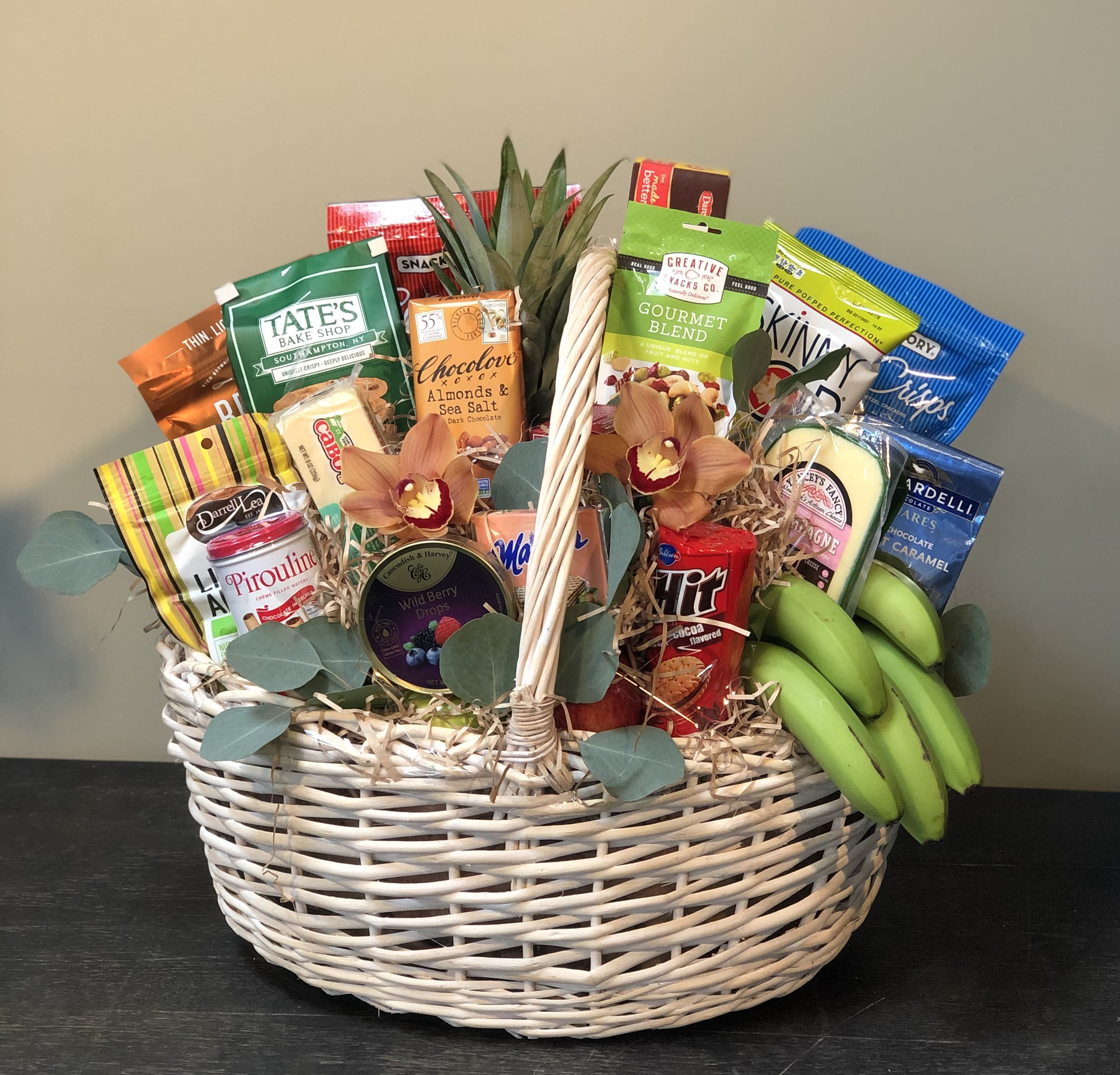 Divine Gourmet Basket Divine Gourmet Basket - The Divine Gourmet Basket is the best gift to make a lasting impression. It holds all kinds of fresh fruit - from apples and pears to bananas and oranges - gourmet chocolates and cookies, cheeses, sausages, crackers and more. Plus, it's all wrapped and ribboned in a big delightful basket.