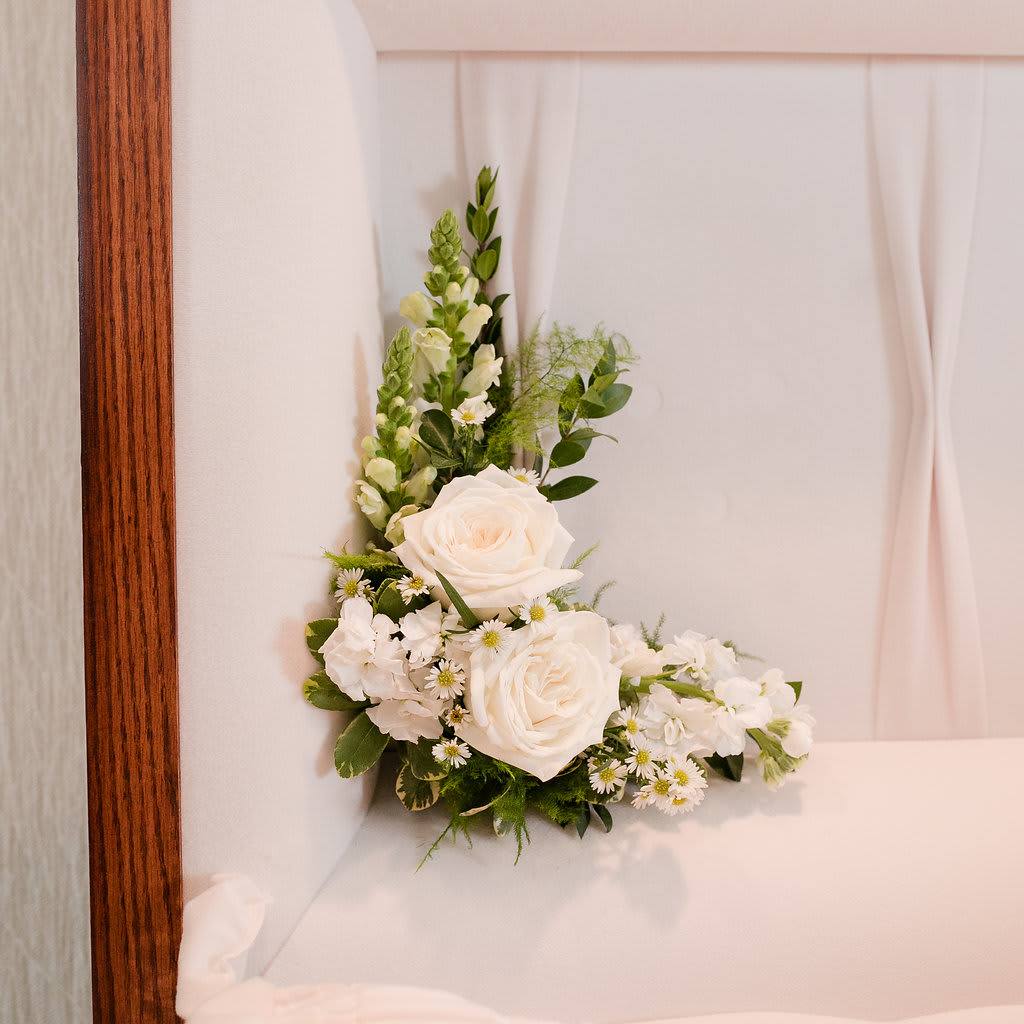 Angelic - A sweet, delicate all white piece to gracefully adorn the corner of the casket. This casket insert is perfect for immediate family members who would like something near their loved one. Please note that this is pinned into the casket by the funeral director.  Approximate Size: 10&quot;H x 10&quot;W