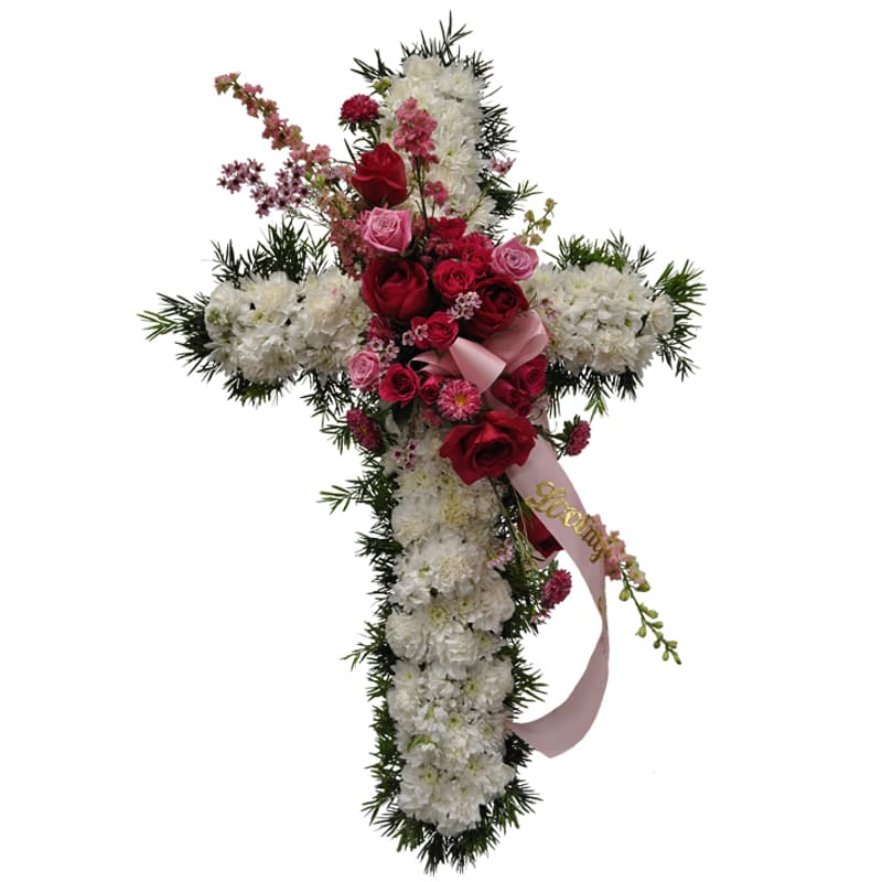 K645 Angel's Embrace 36" Cross Tribute K645 Angel's Embrace 36" Cross Tribute - K645 Angel's Embrace 36' Cross Tribute This beautiful white cross, adorned with a red rose and a pink floral cluster, serves as a heartfelt tribute for a funeral. Symbolizing all the things the cross embraces, this lovely piece expresses love and remembrance. The floral cluster can be customized with red roses and white flowers for a man, creating an equally appropriate and beautiful tribute. This arrangement is a touching way to honor and remember your loved one.