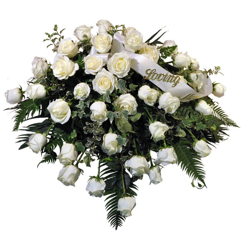K604 Peaceful Light Casket Spray K604 Peaceful Light Casket Spray - K604 There is something truly pristine and pure about all-white roses, making them a timeless choice for expressing love and deep emotions when we lose a loved one. Our Peaceful Light White Rose Casket Spray is an elegant tribute that symbolizes peace, honor, and remembrance. This arrangement is designed for an open casket, gracefully adorning the display with a serene touch. For a closed casket, we offer a premium-sized option that reflects an enhanced collection of exquisite white roses, creating an even more profound and beautiful expression of love. Whether honoring a loved one with an open or closed casket, this casket spray offers a heartfelt tribute that conveys the purity of your sentiments during this difficult time.